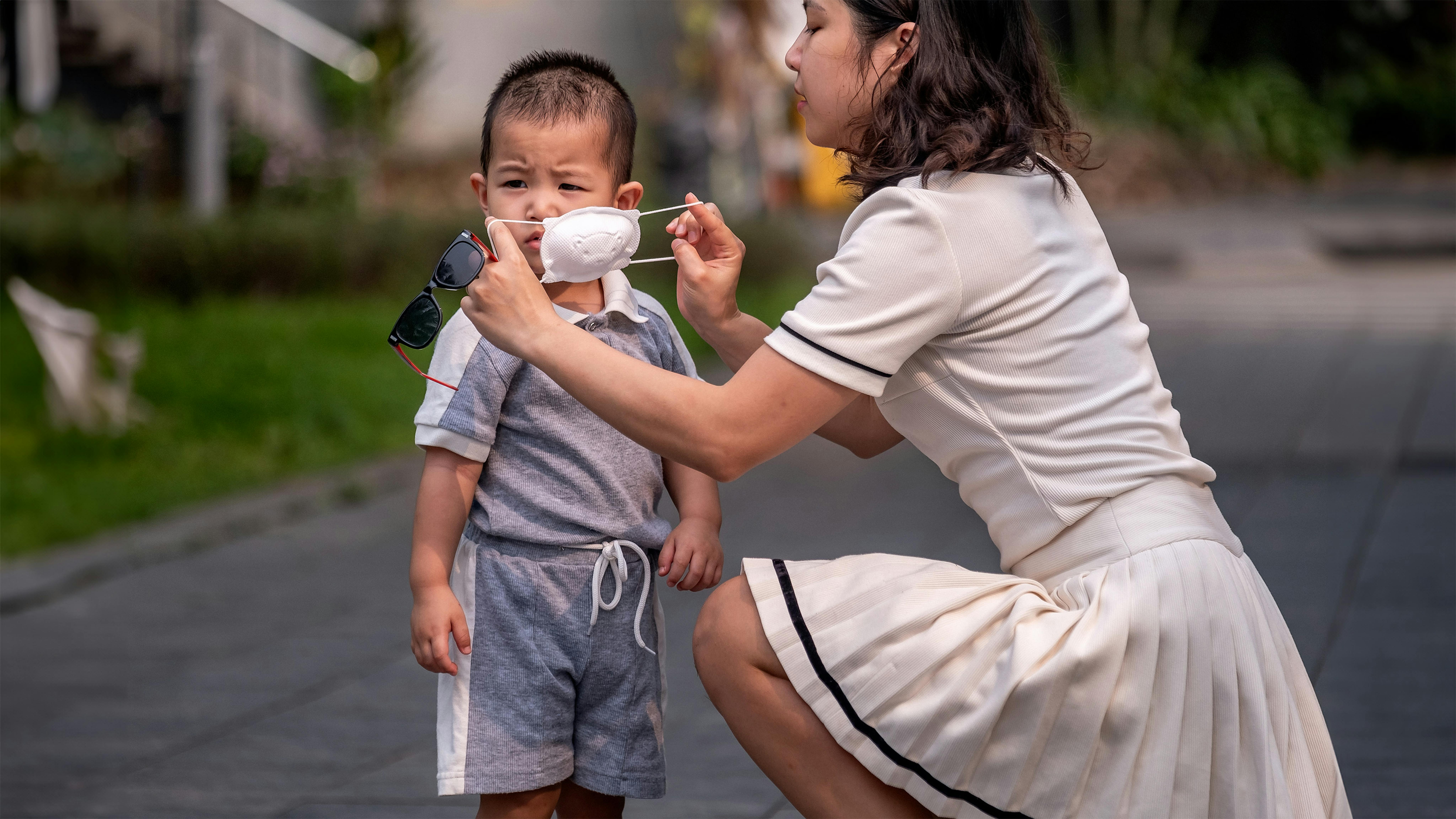 Vietnam - Bui Hoang The Bao, 3 anni, indossa una maschera per andare con sua madre Hoang Phuong Thao, 33 anni, in un parco in una zona residenziale alla periferia di Ha Noi.