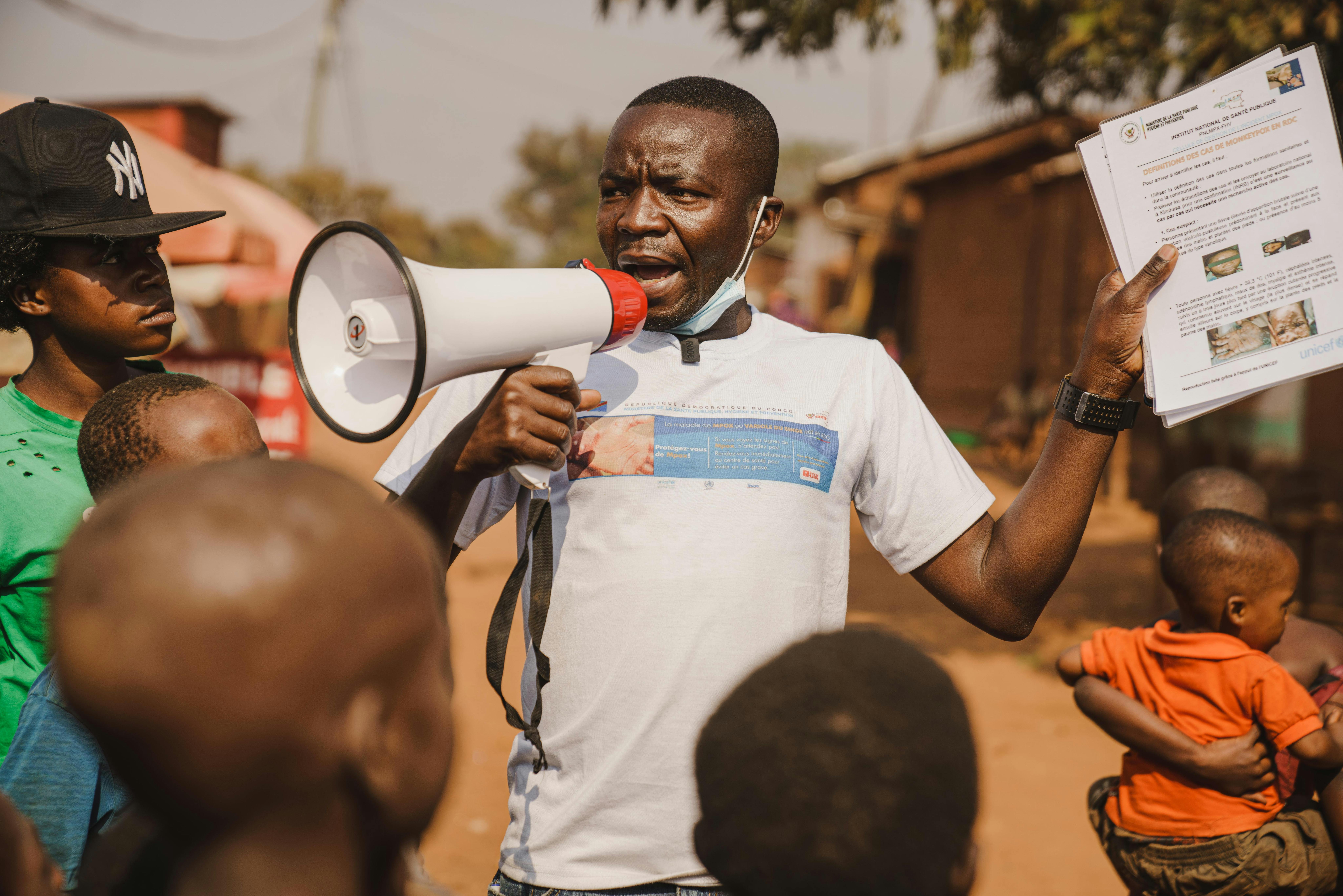 Innocent Murula, un operatore di comunità, usa il suo megafono per sensibilizzare la comunità sul mpox a Kamanyola, provincia del Sud Kivu, Repubblica Democratica del Congo.
