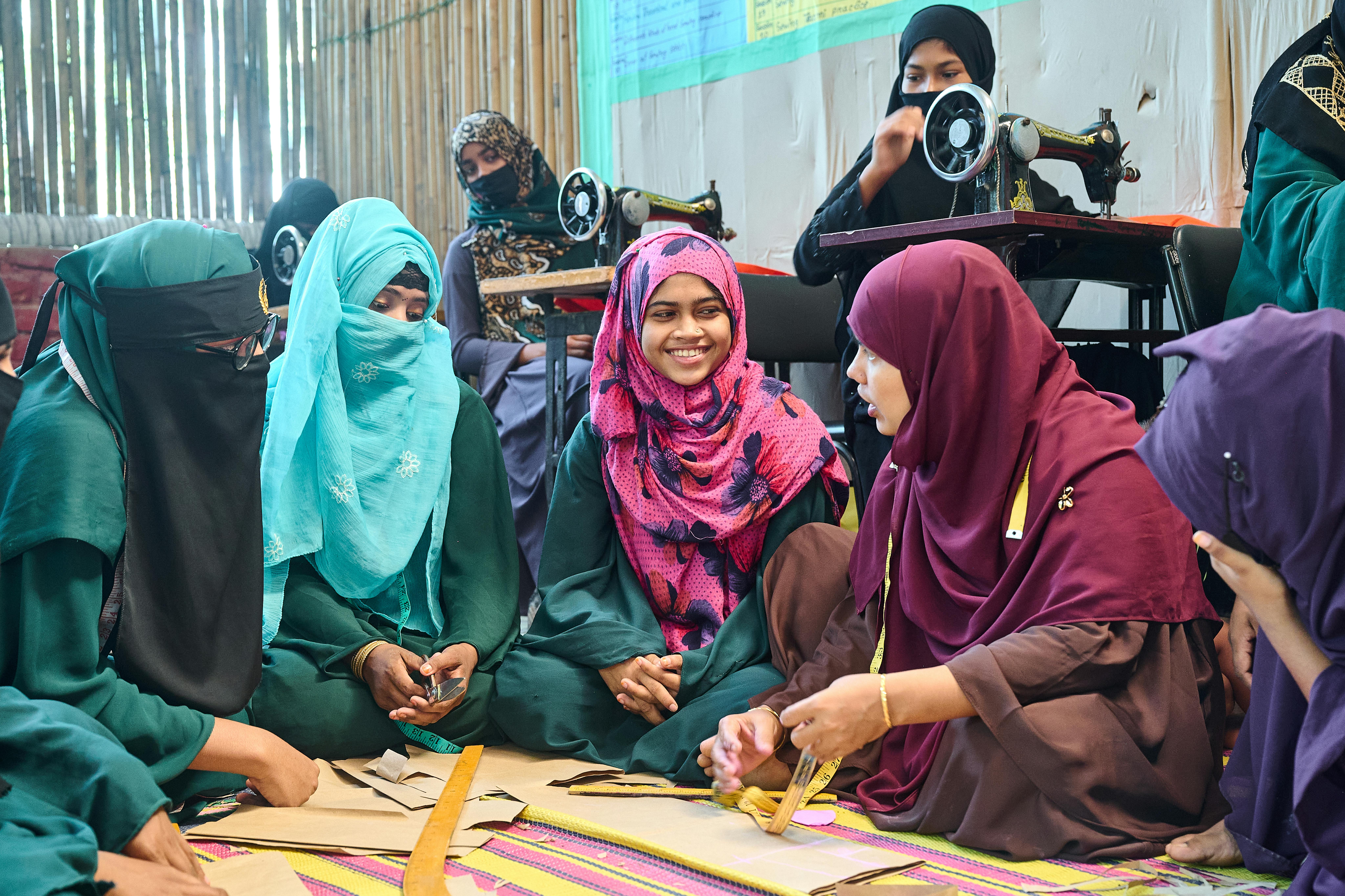 Azida Begum, interagisce con le sue coetanee e la sua maestra di cucito durante un corso di formazione professionale in un centro polifunzionale nei campi profughi Rohingya di Cox's Bazar, in Banglades
