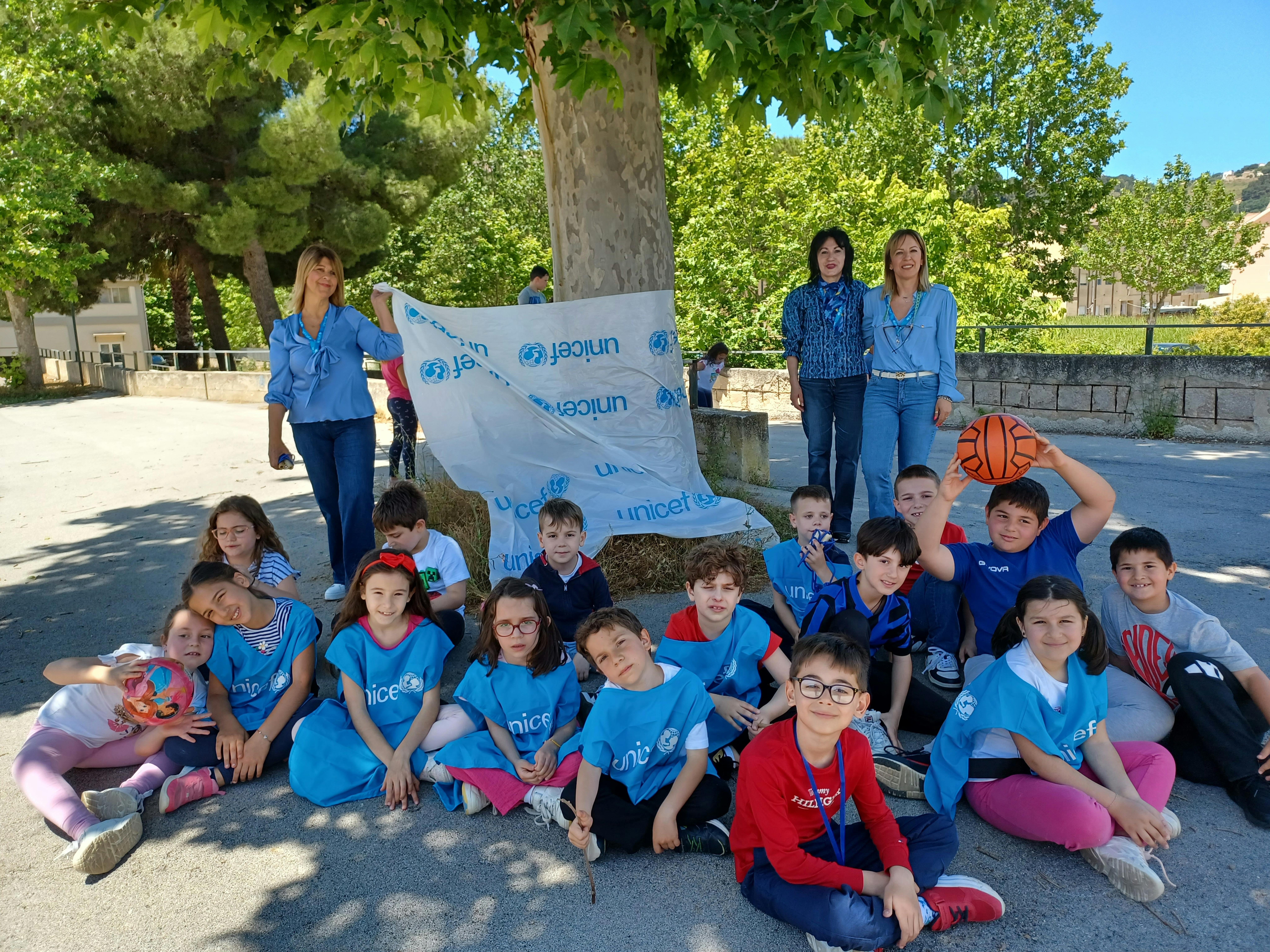 I bambini riposano all'ombra di un grande albero