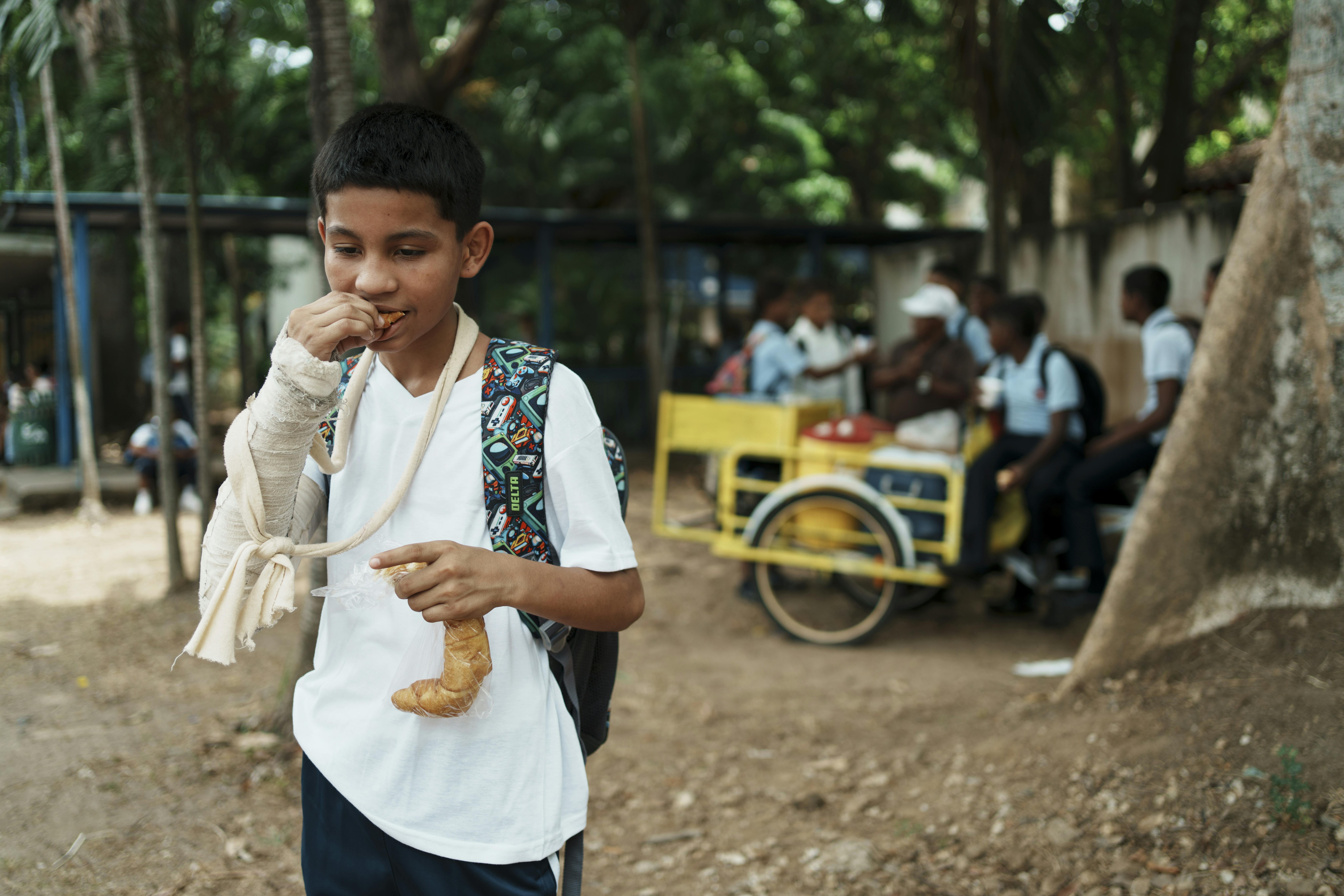 Karlos, 13 anni, sta consumando una brioche appena acquistata dal chiosco che si trova nella sua scuola. Non ci sono alternative salutari per lui.