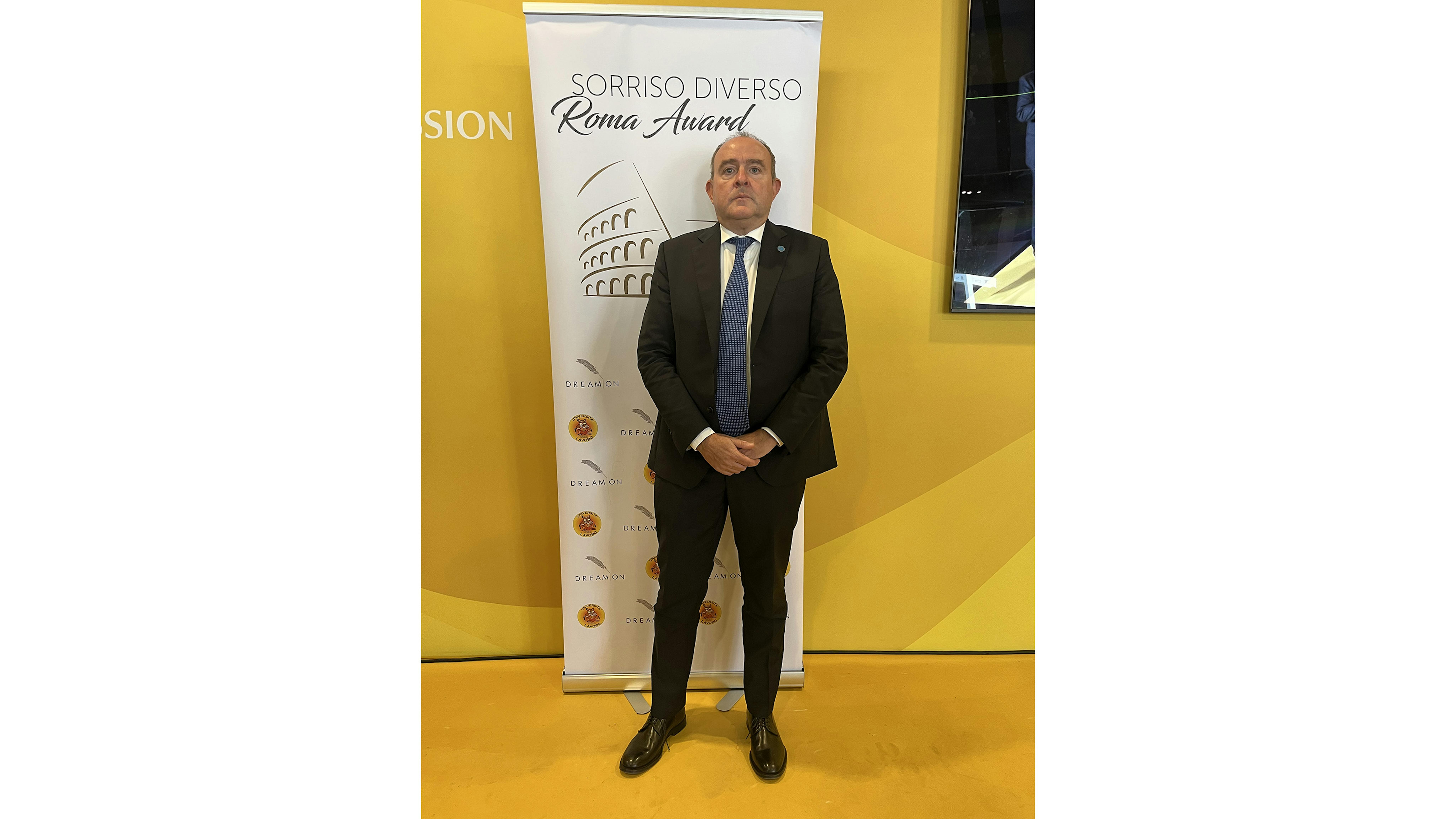 Nicola Graziano, Presidente dell'UNICEF Italia in posa con la locandina di Sorriso Diverso Roma Award