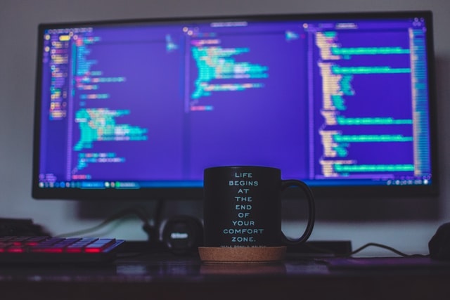 monitor and a coffee mug