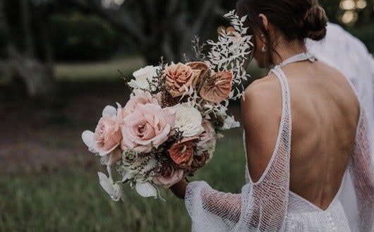 Back View Bride Holding Flower