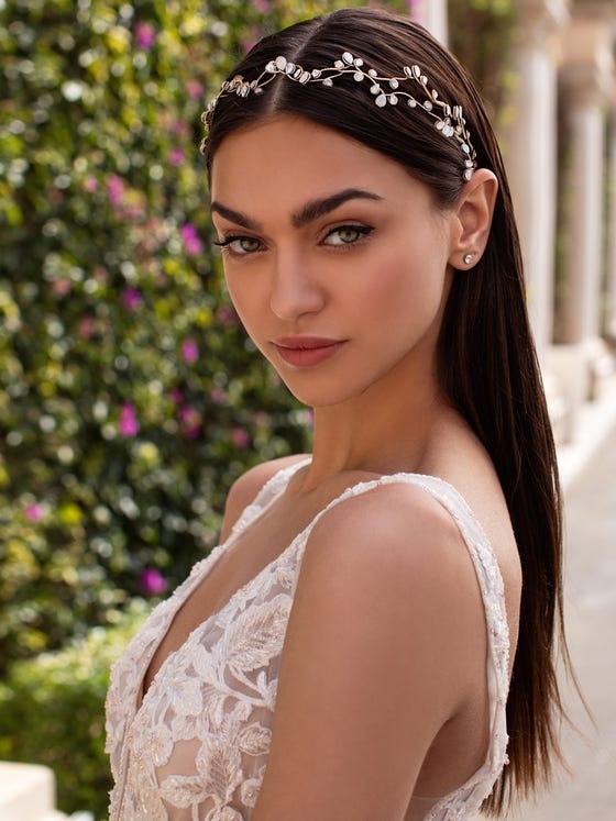 Close up of bride with straight hair wearing an embellished headband 