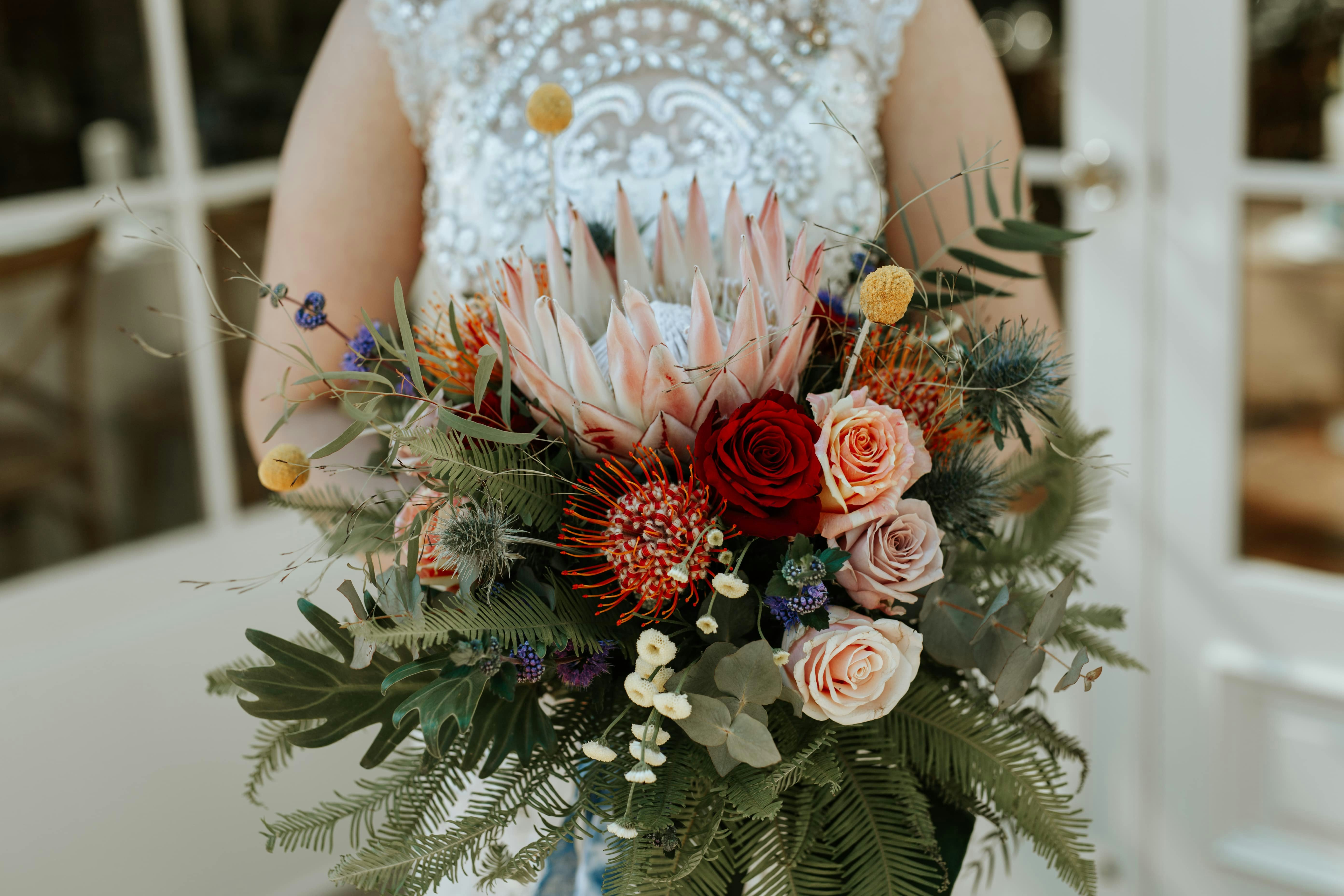 Bride holding bouquet with Australian Natives and roses 
