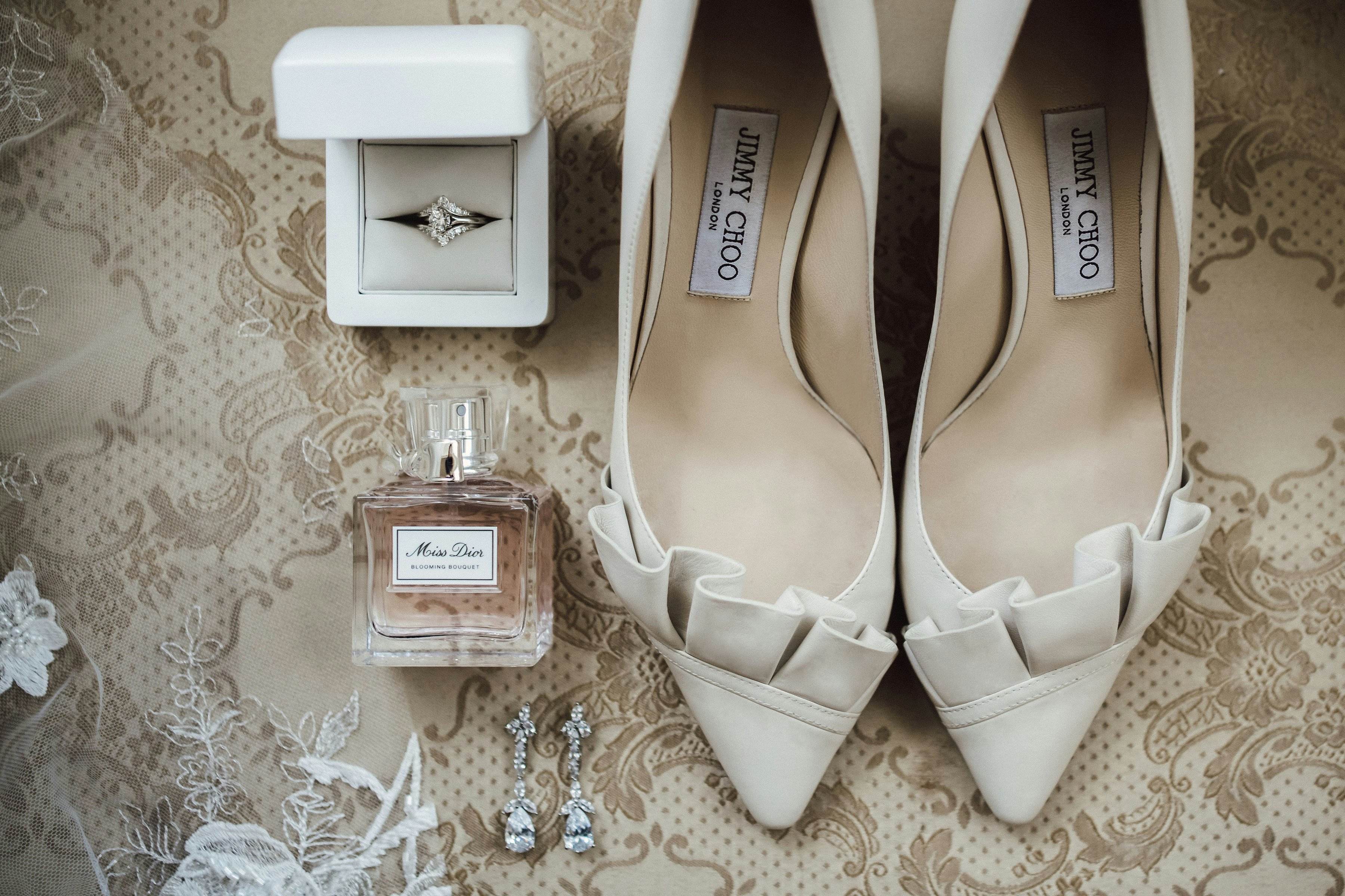 Wedding shoes, perfume and ring in a ring box