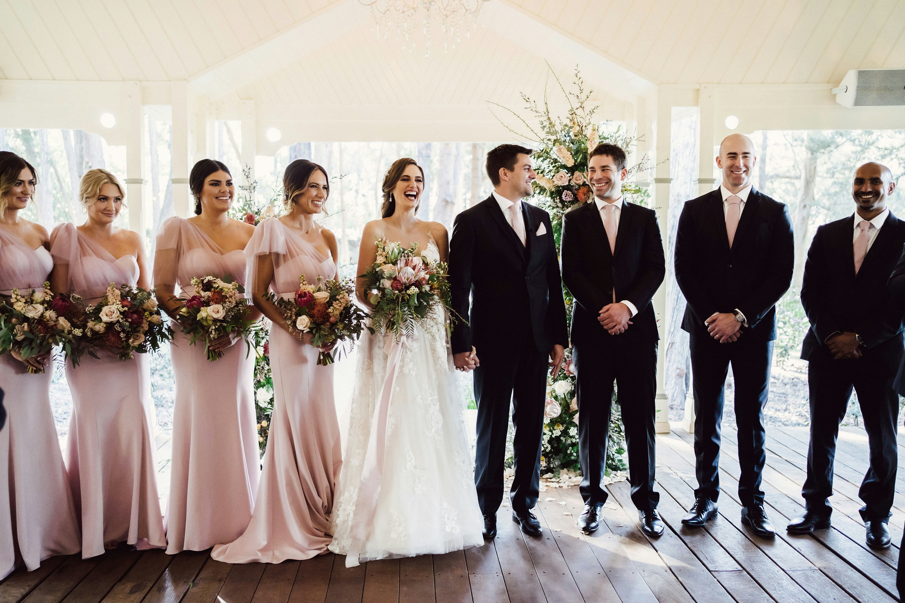 Bride and groom standing with their wedding party 