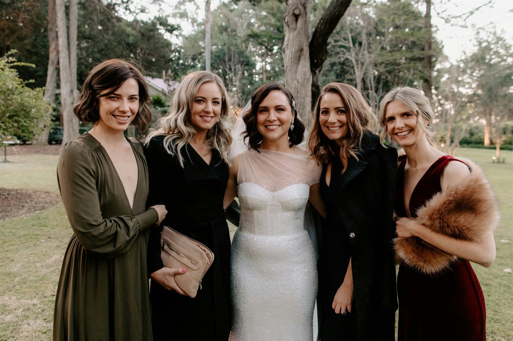 Bride standing with bridesmaid and friends 
