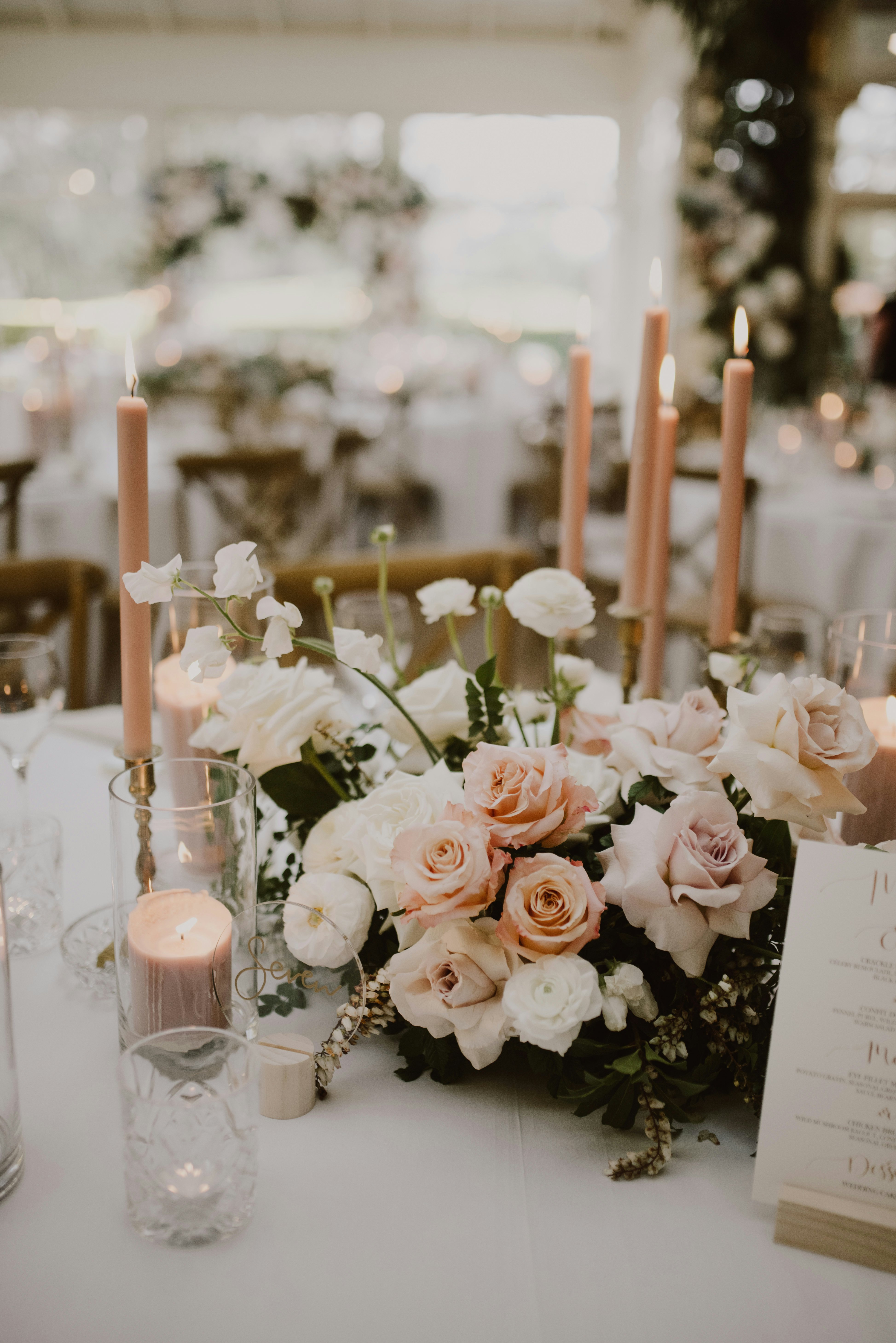 Table setting at wedding with pink roses and candles 