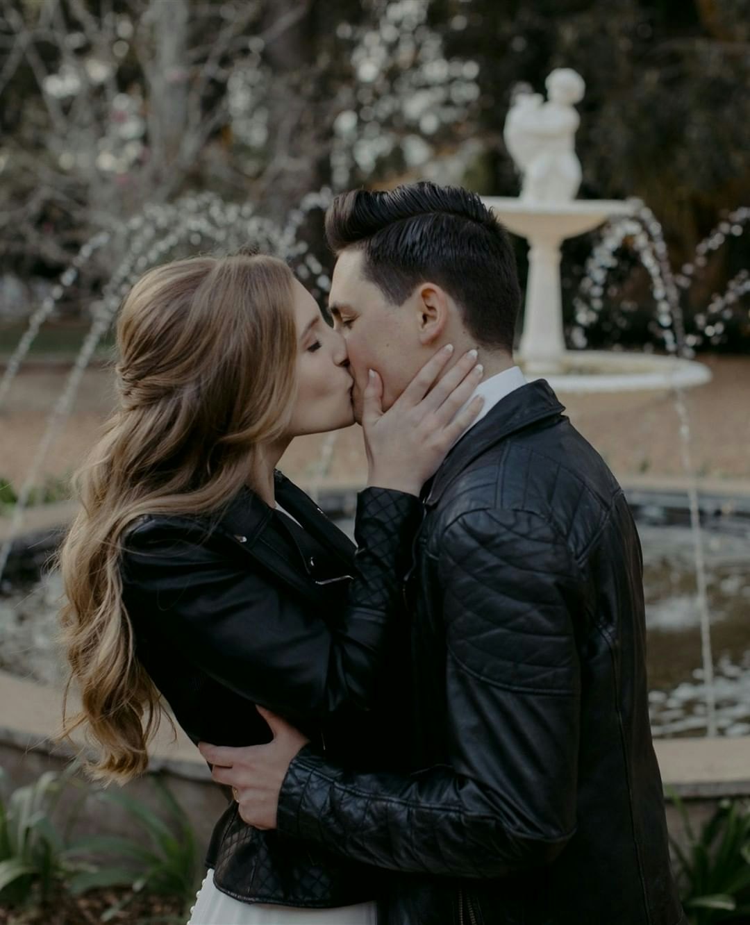 Bride and Groom kissing in leather jackets 