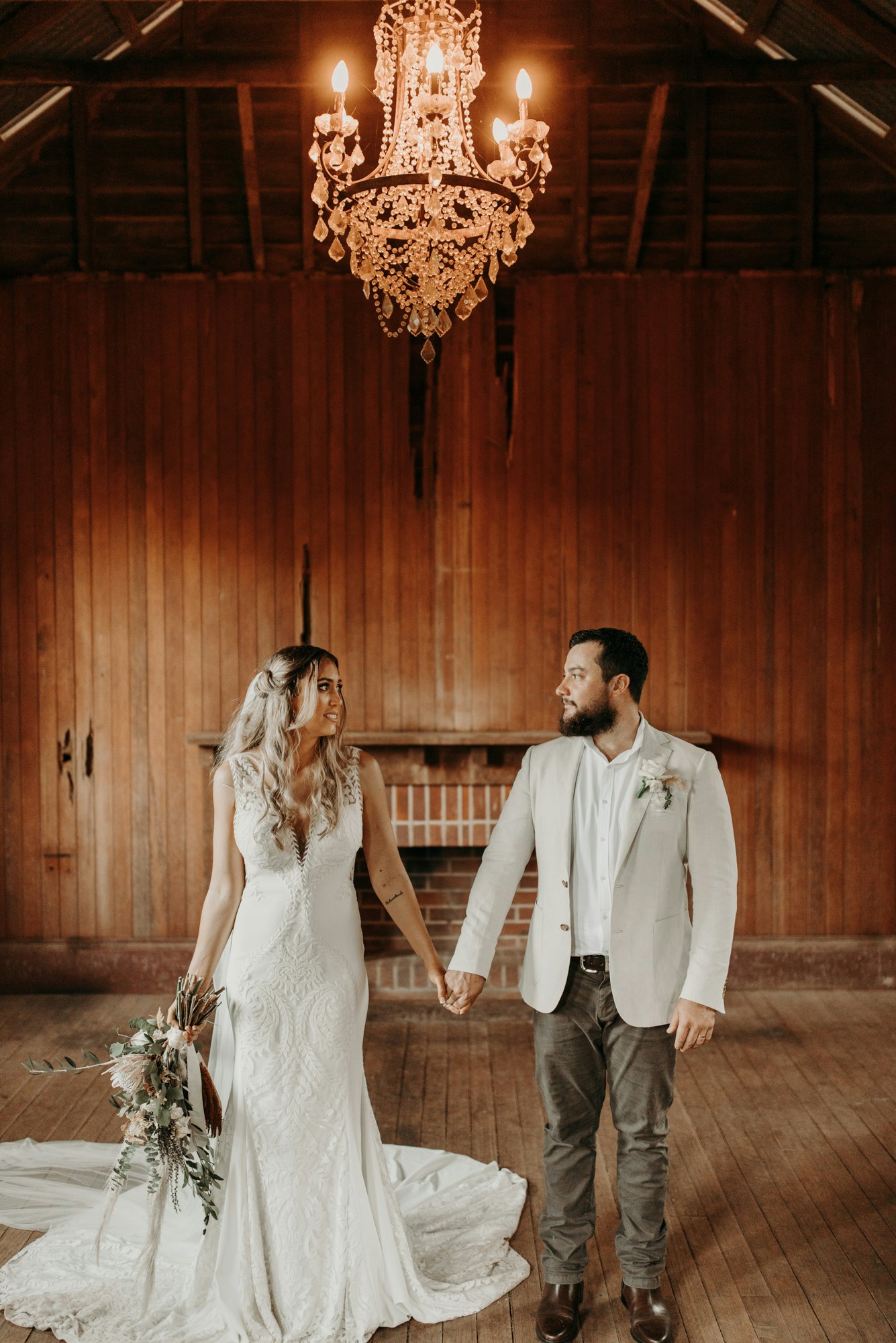 Bride and Groom holding hands in old school house 