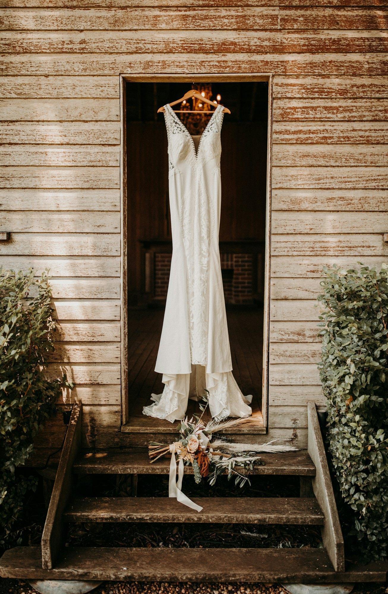 Wedding dress hanging in doorway 