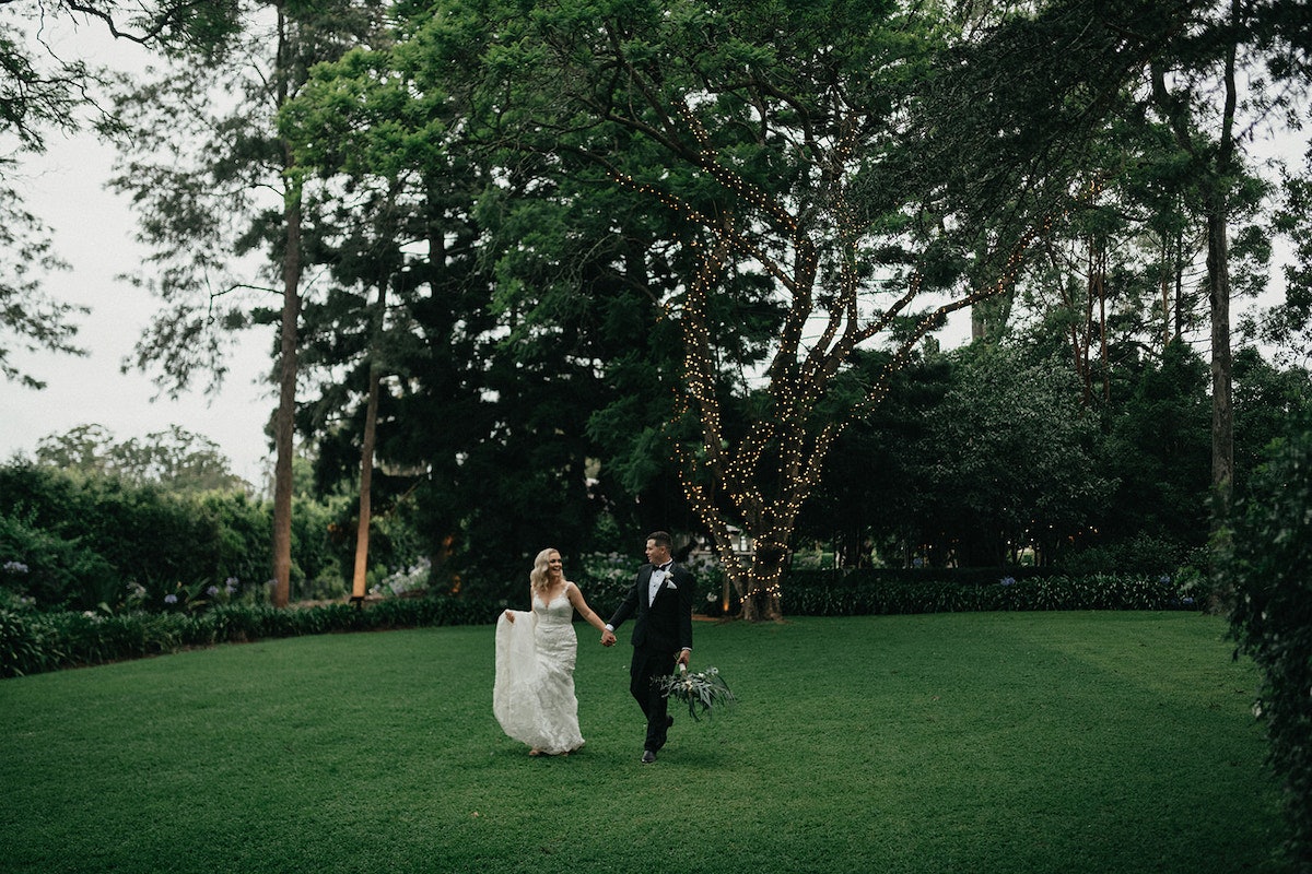 Bride and Groom walking through gardens 