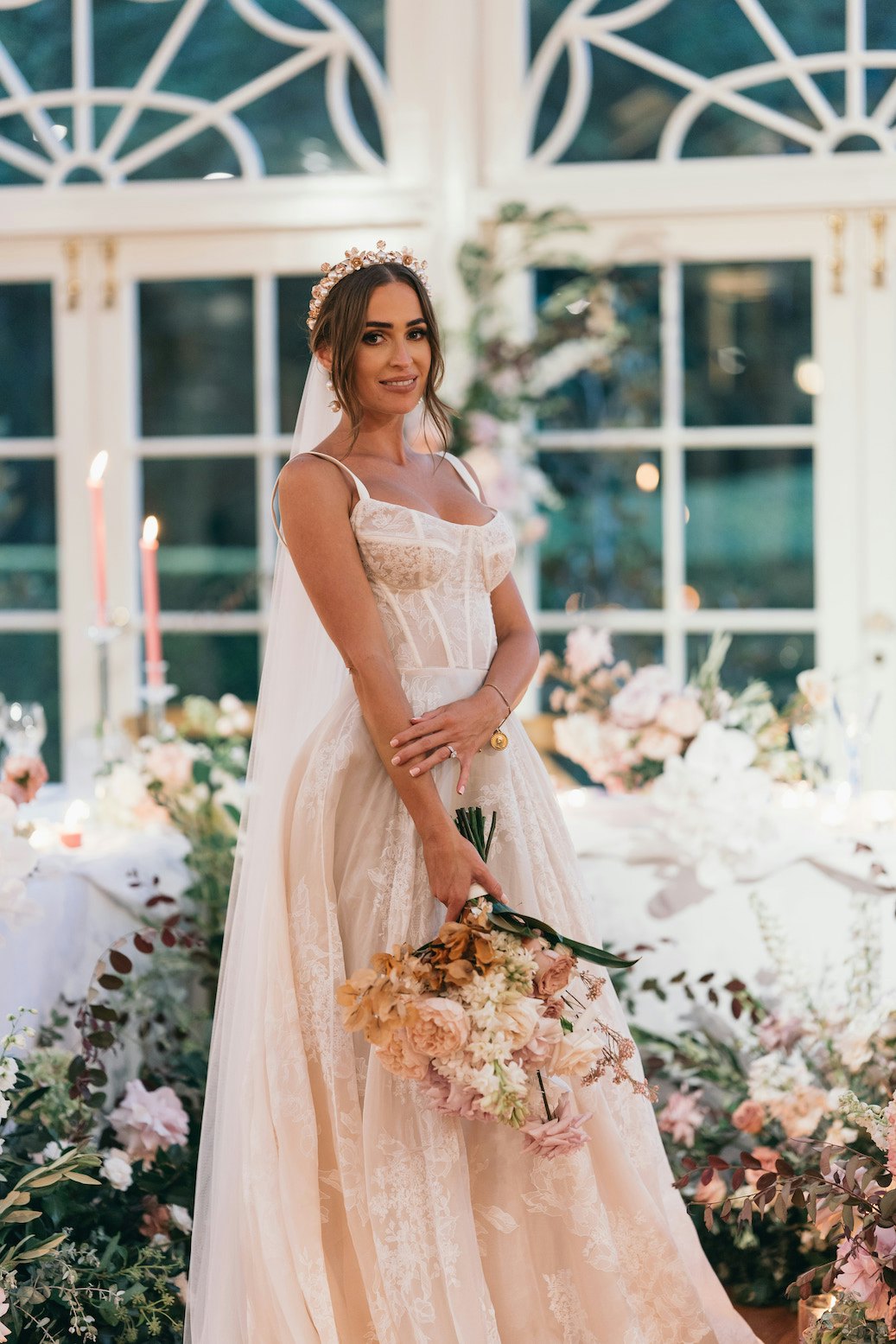 Bride in front of flowers in bridal table 