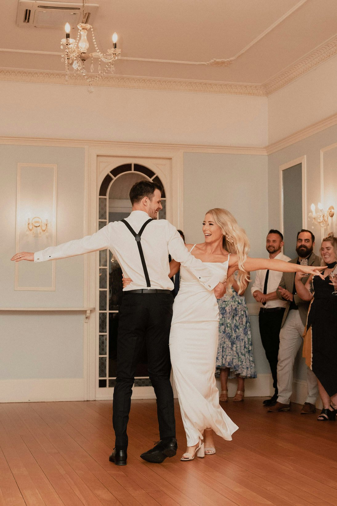 Bride and groom dancing in ballroom 
