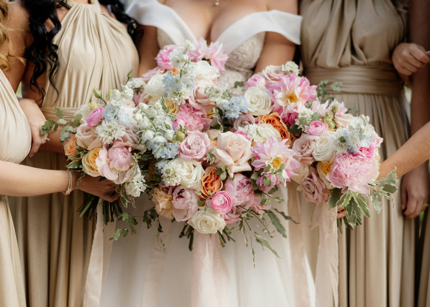 Bride and bridesmaids holding flowers 