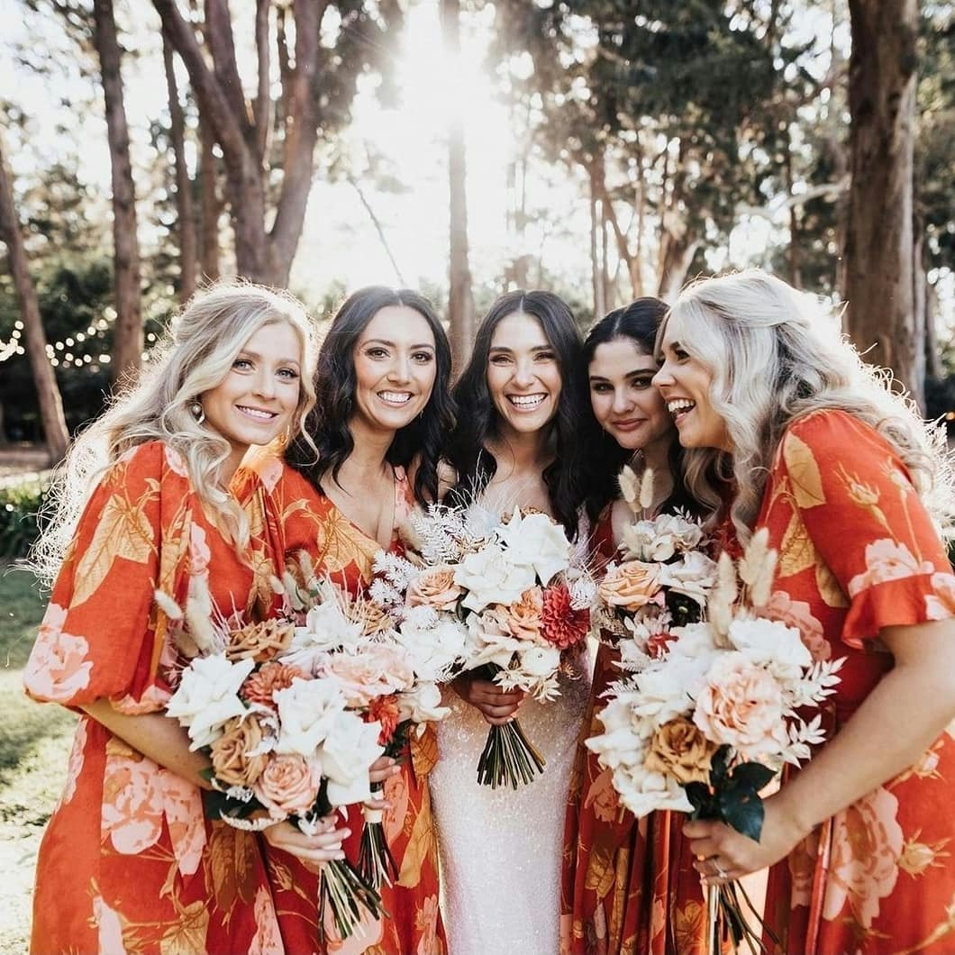 Bride and bridesmaids holding bouquets 