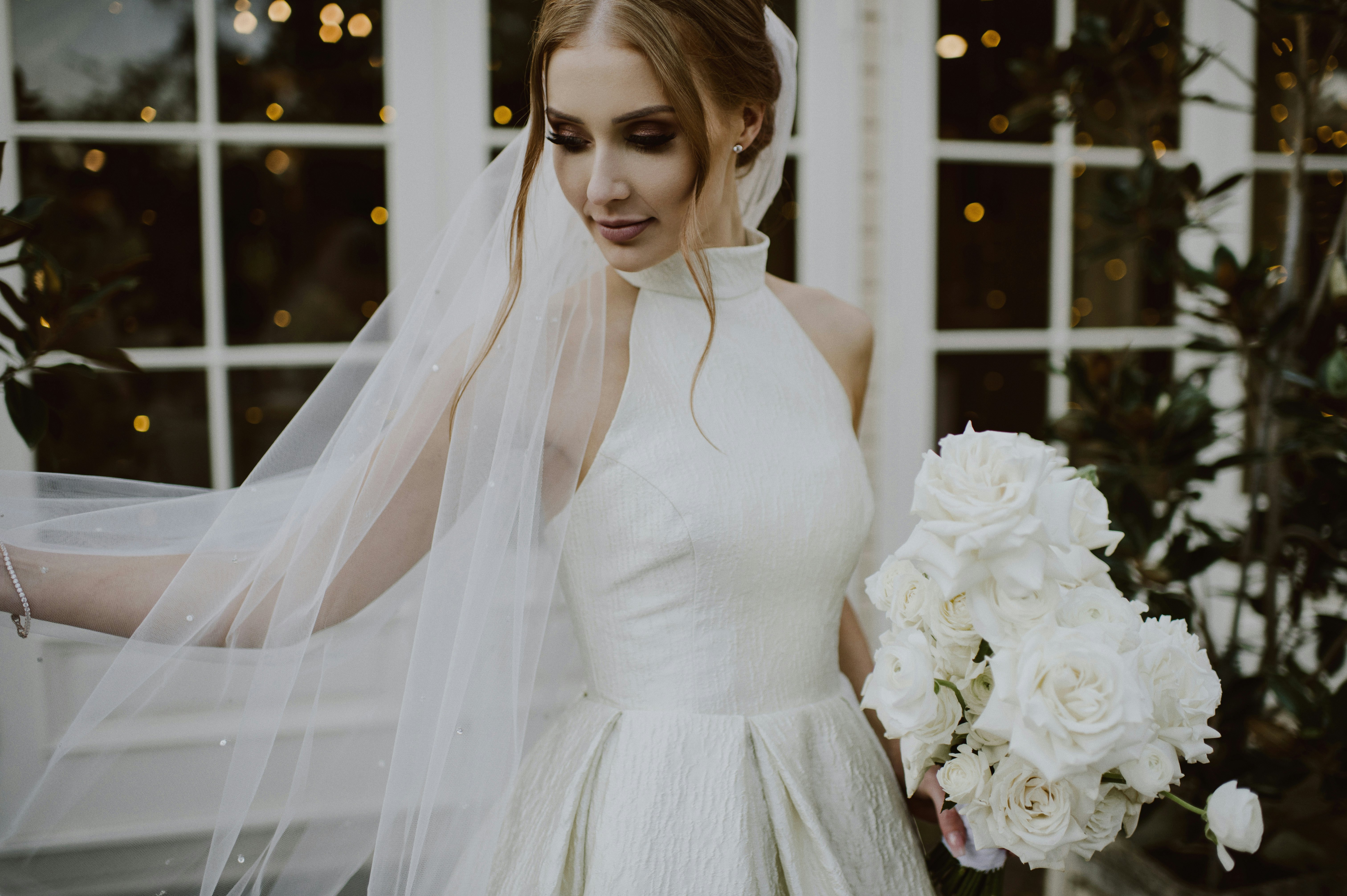 Bride with high neck dress holding bouquet 