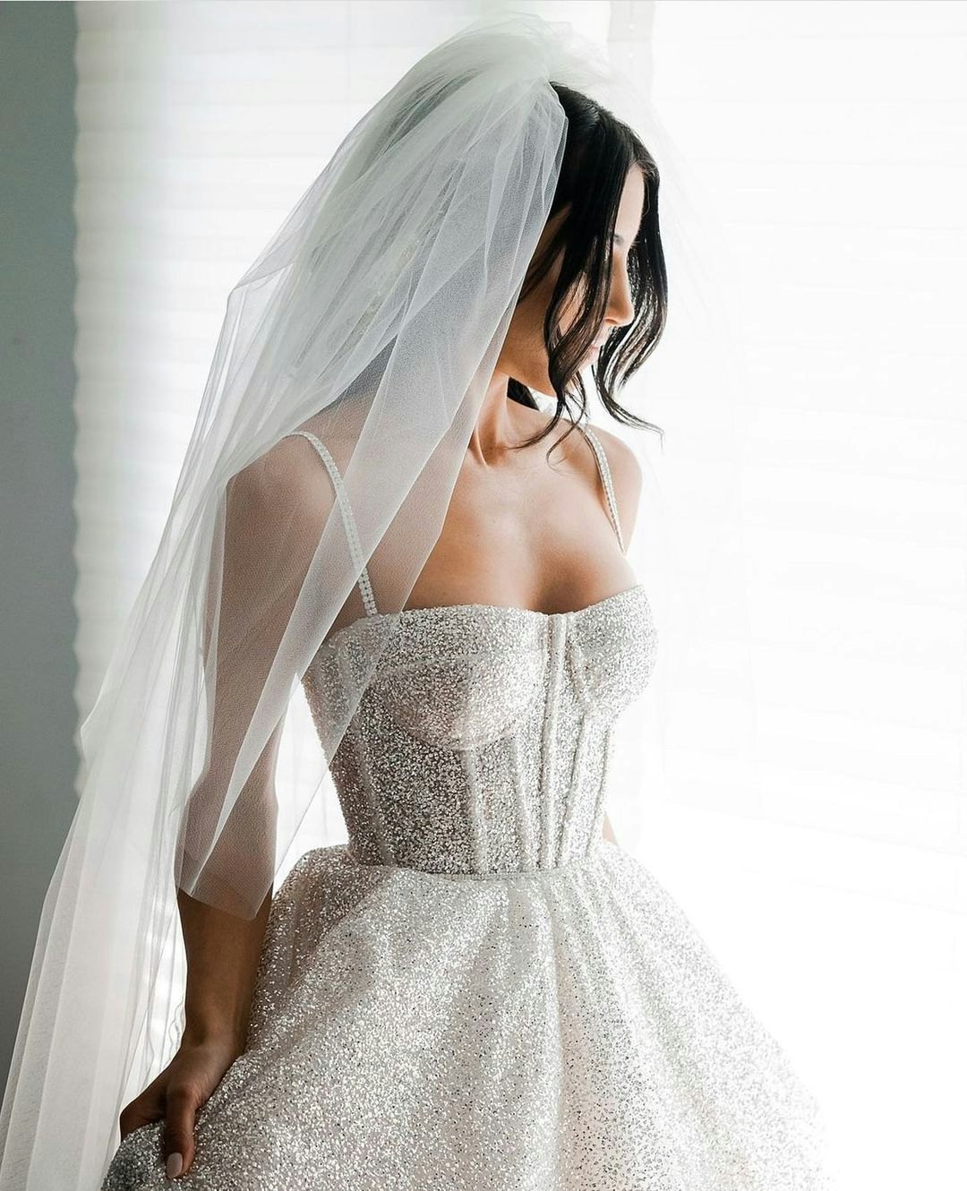 Bride wearing dress with corset and veil 