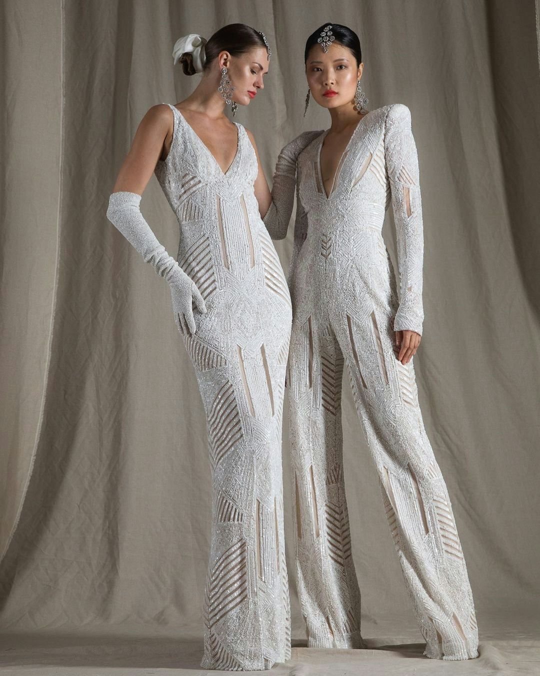 Two brides, one wearing a dress, one wearing a jumpsuit 