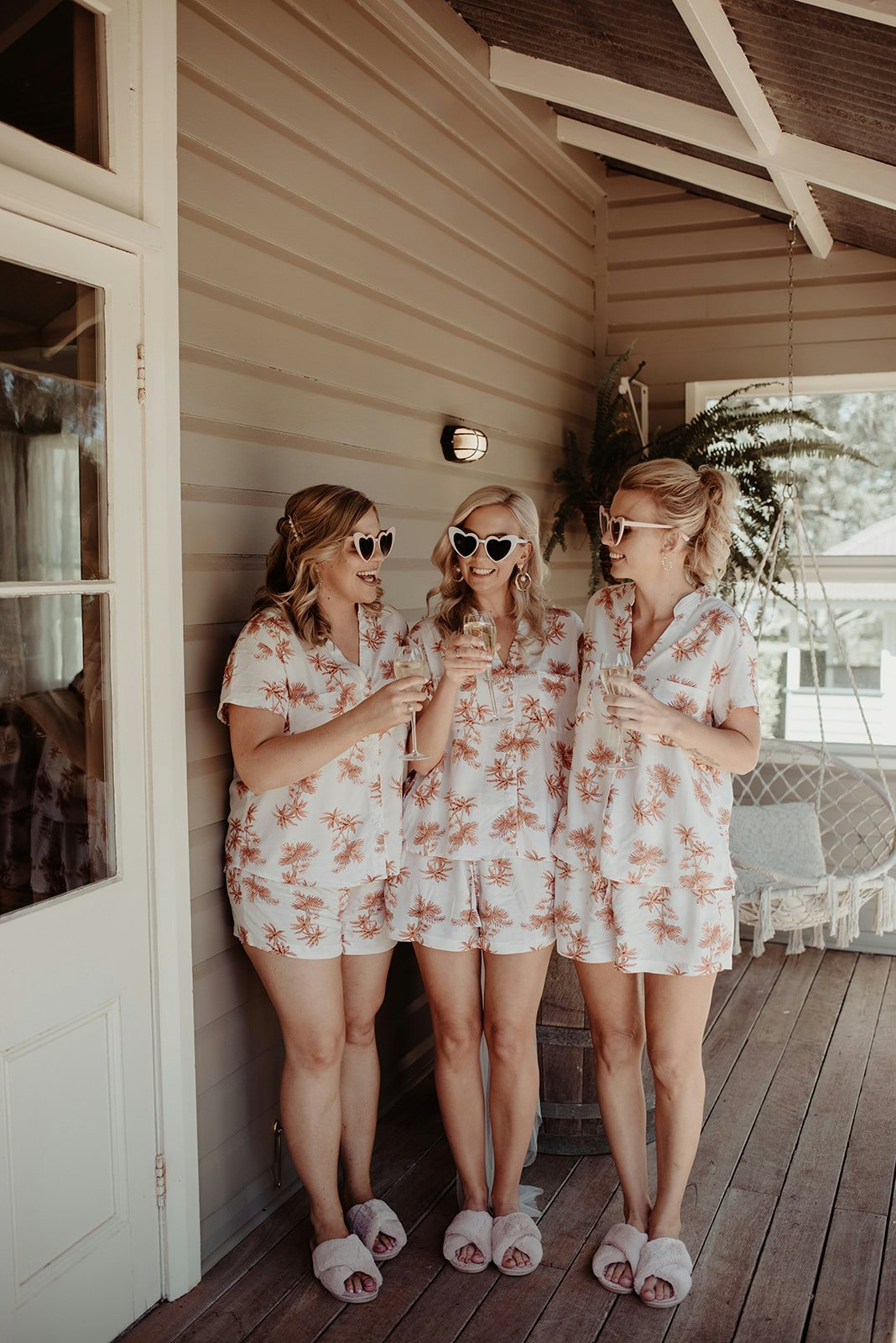 Bridesmaids sipping champagne wearing sunglasses 