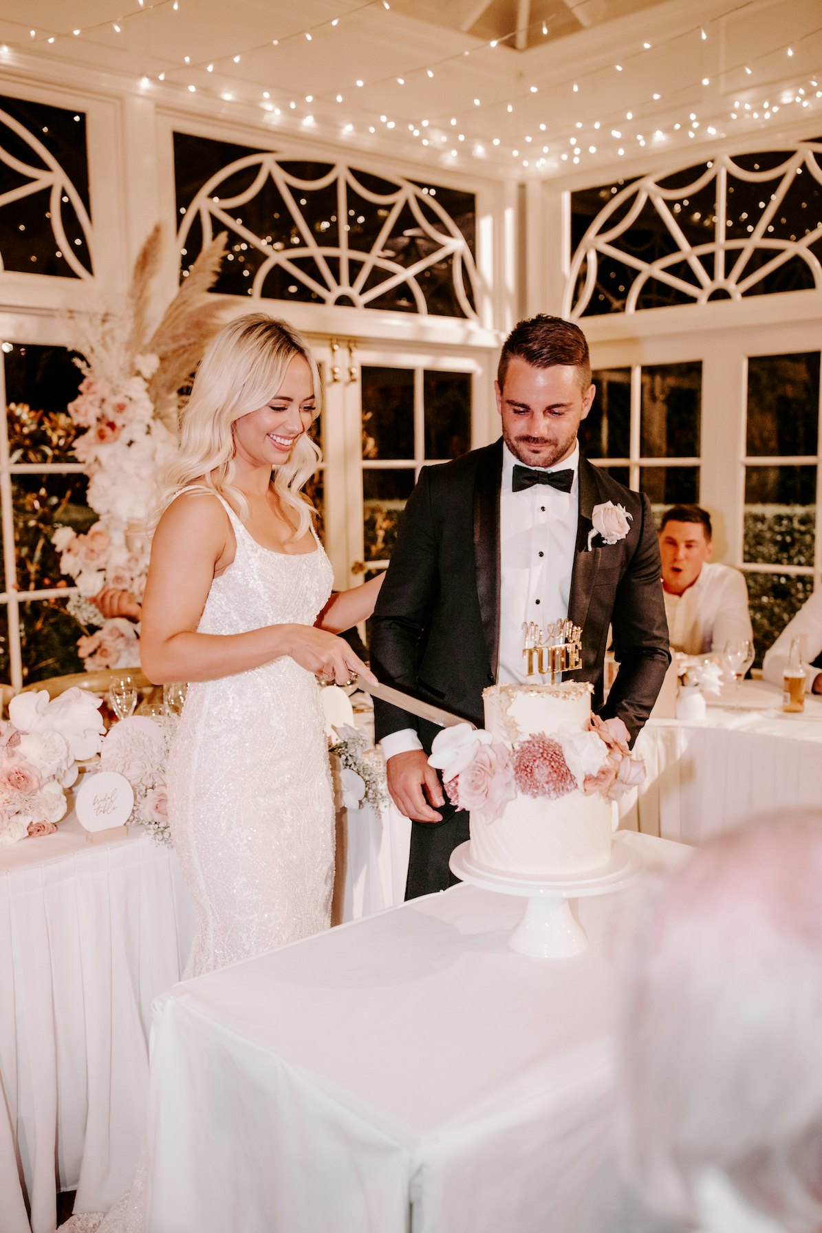 Bride and groom cutting cake 