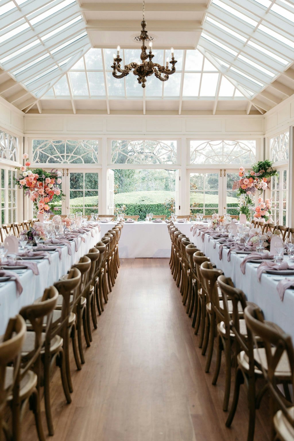 Wedding reception with wooden tables and colourful flowers 
