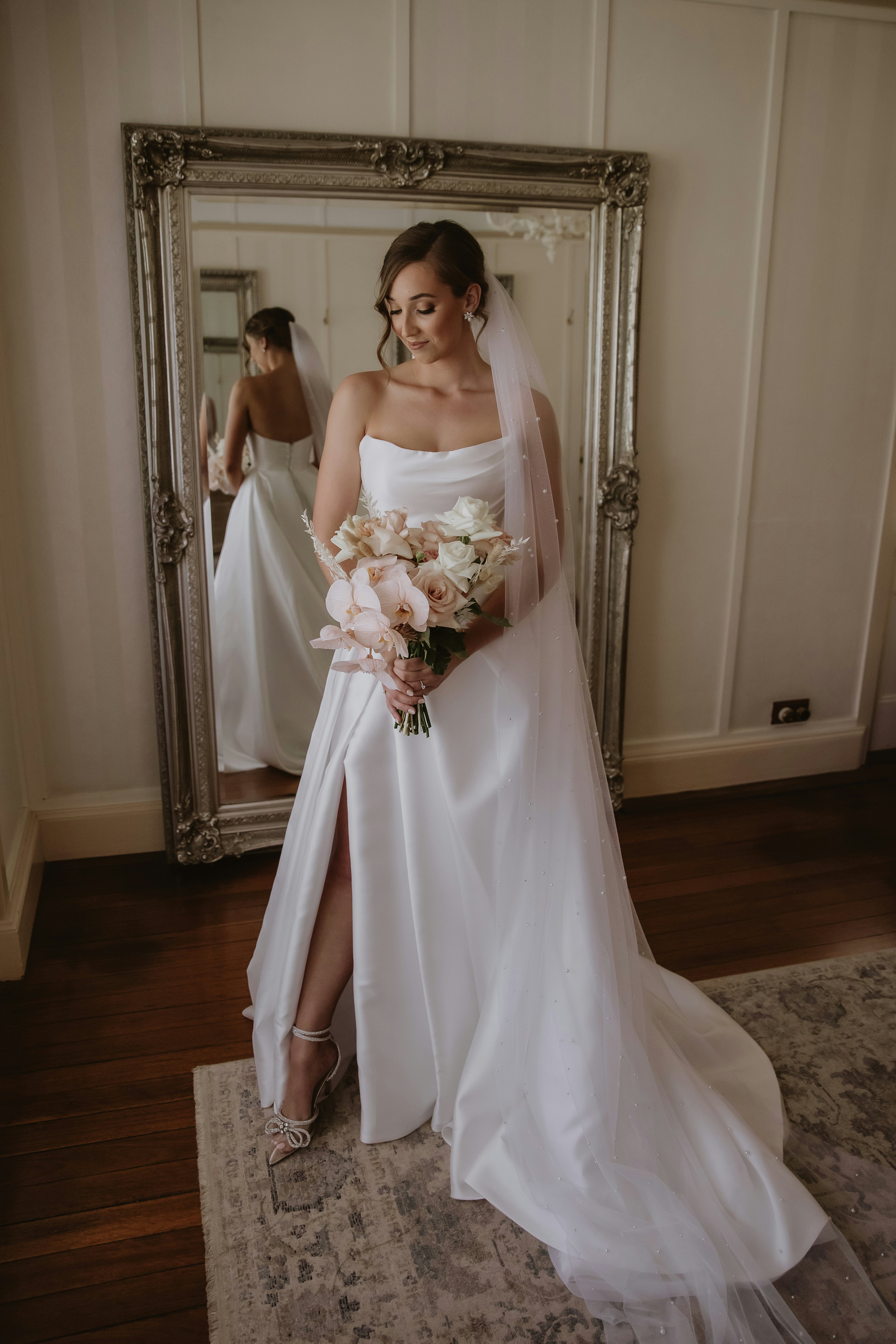 Bride holding bouquet in wedding dress
