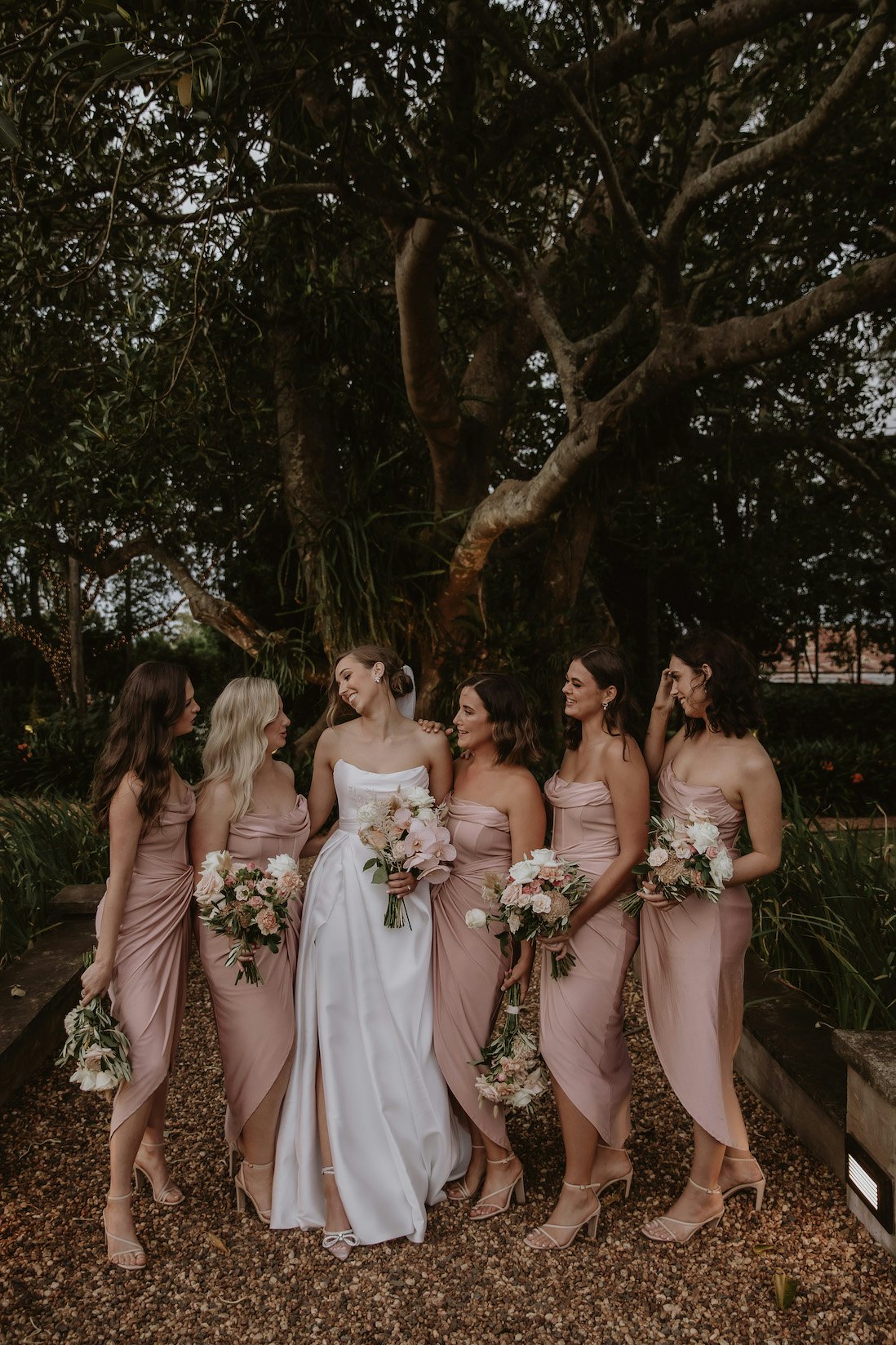 Brides and bridesmaids holding bouquets 