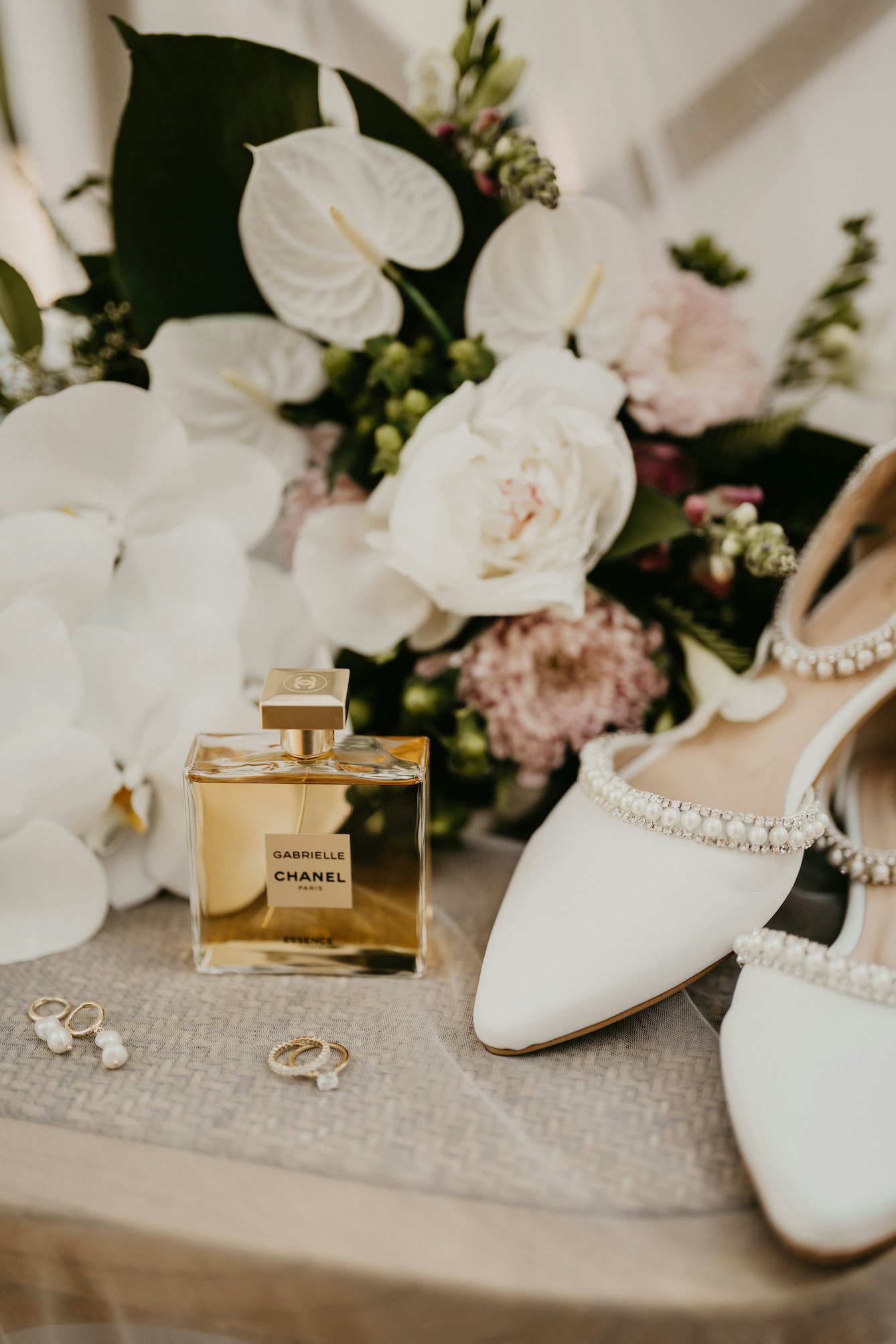 Wedding shoes, perfume and rings 