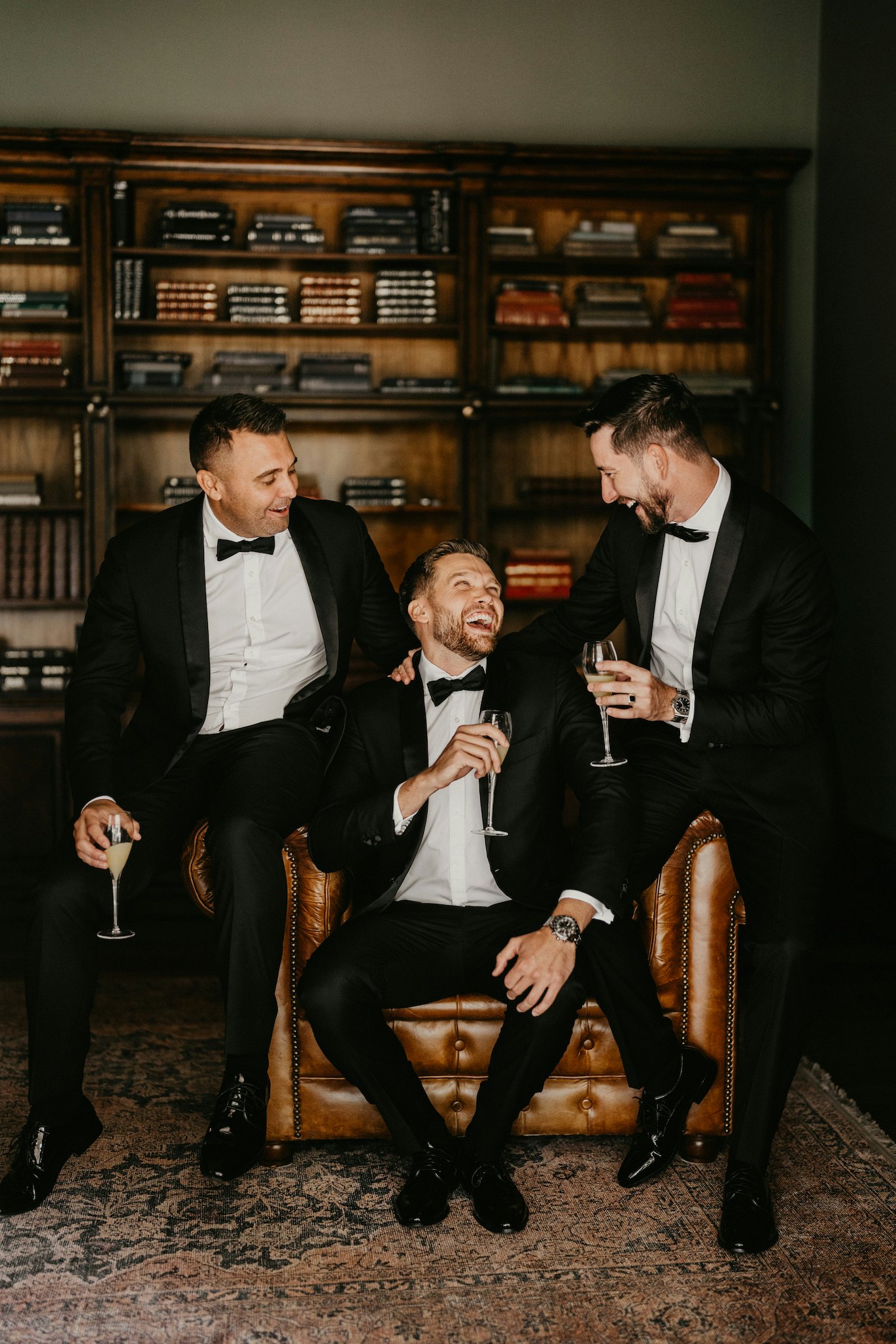 Groom and groomsmen sitting on leather chair