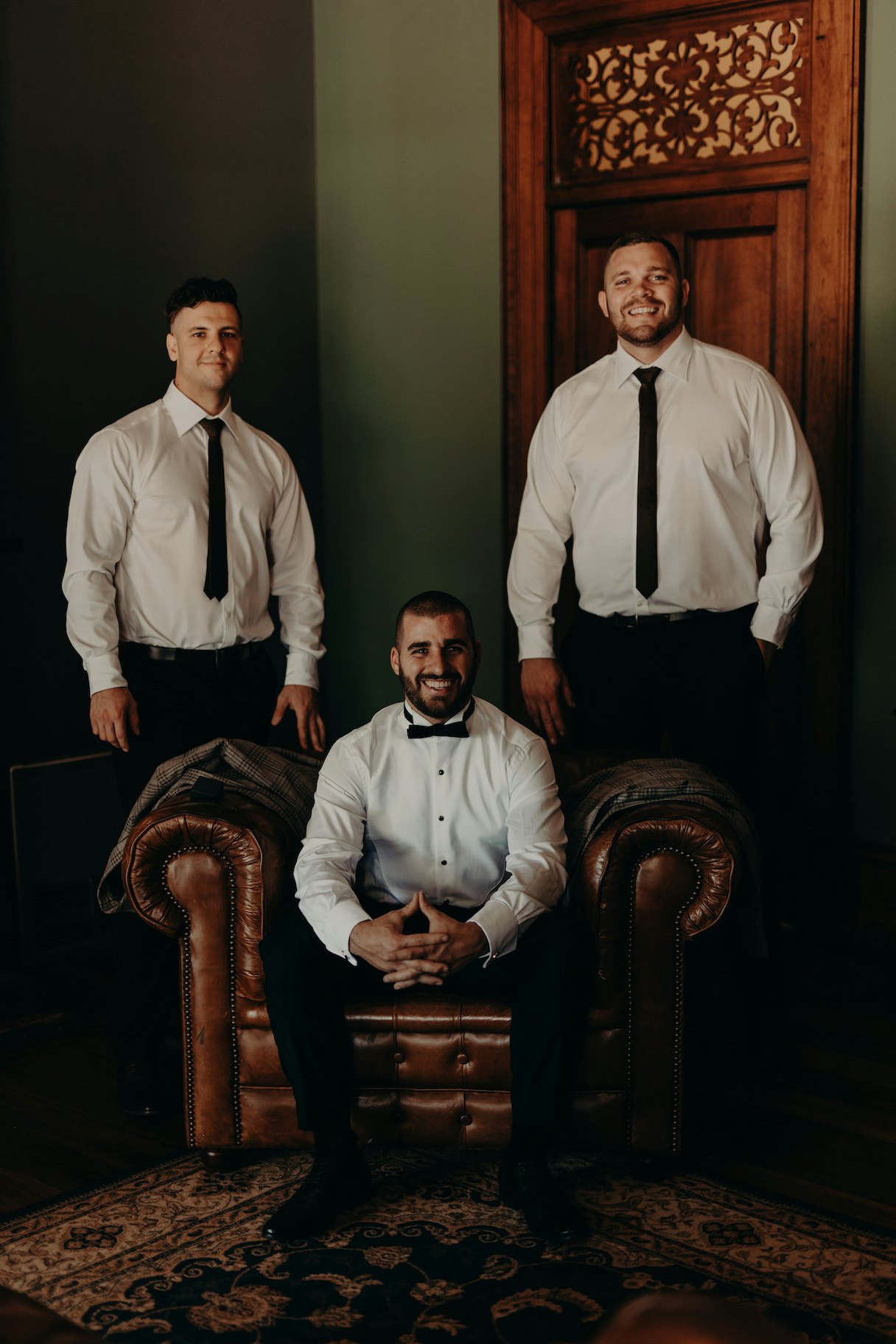 Groomsmen sitting on leather lounges