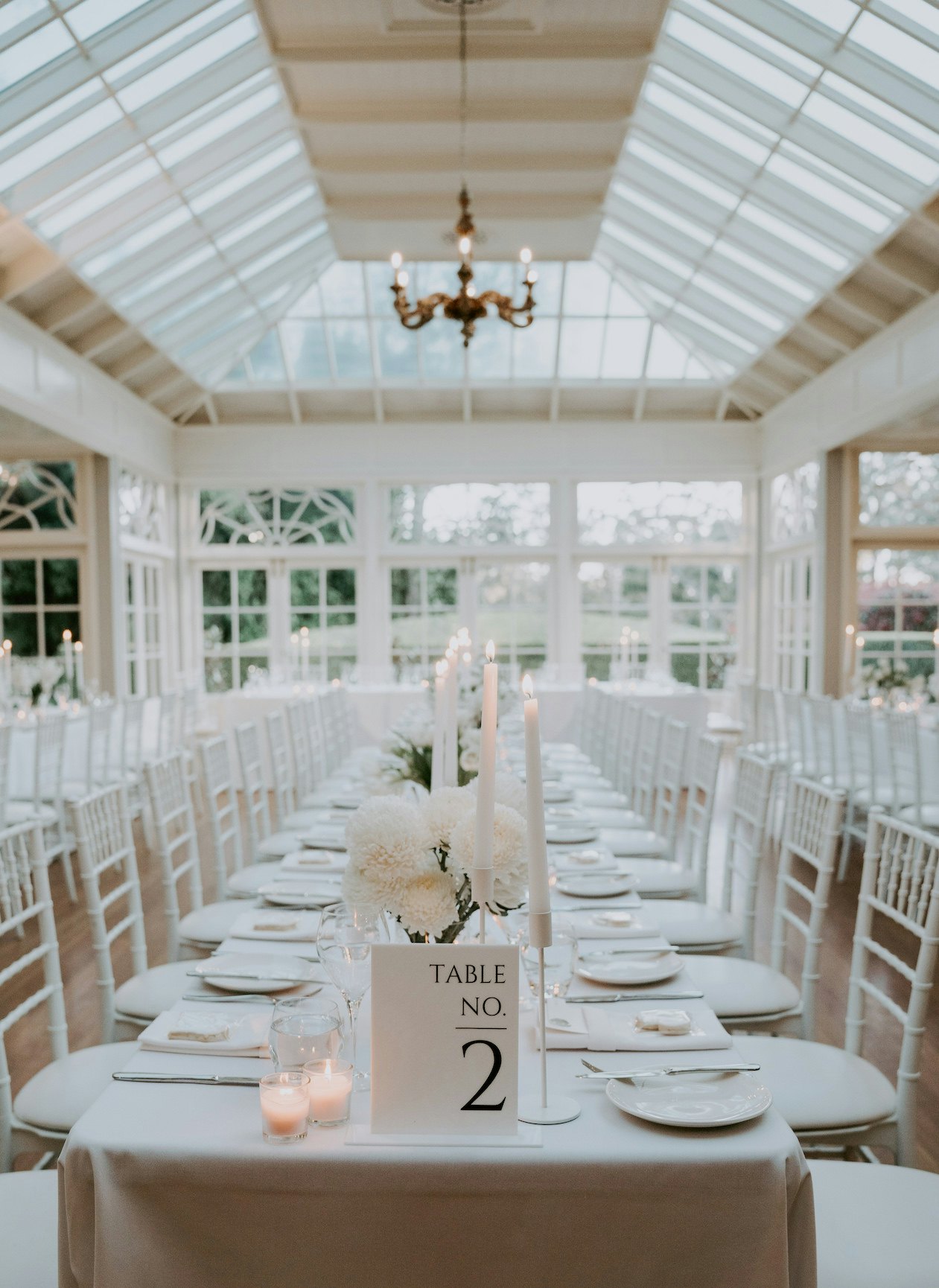 Wedding reception tables with white flowers
