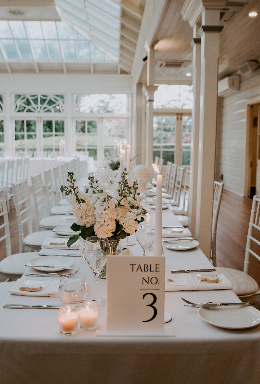 Wedding reception tables with white flowers