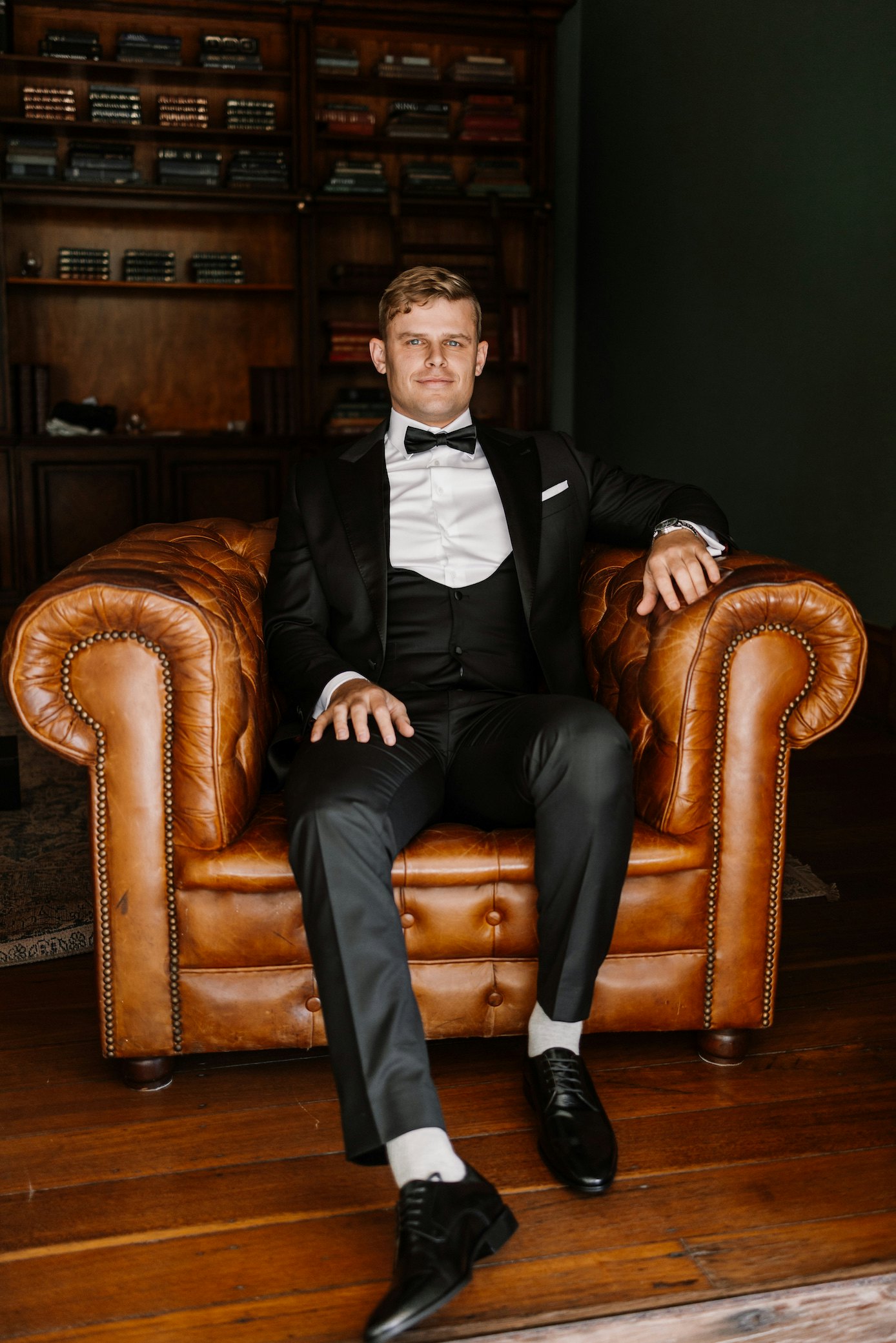 Groom sitting in library