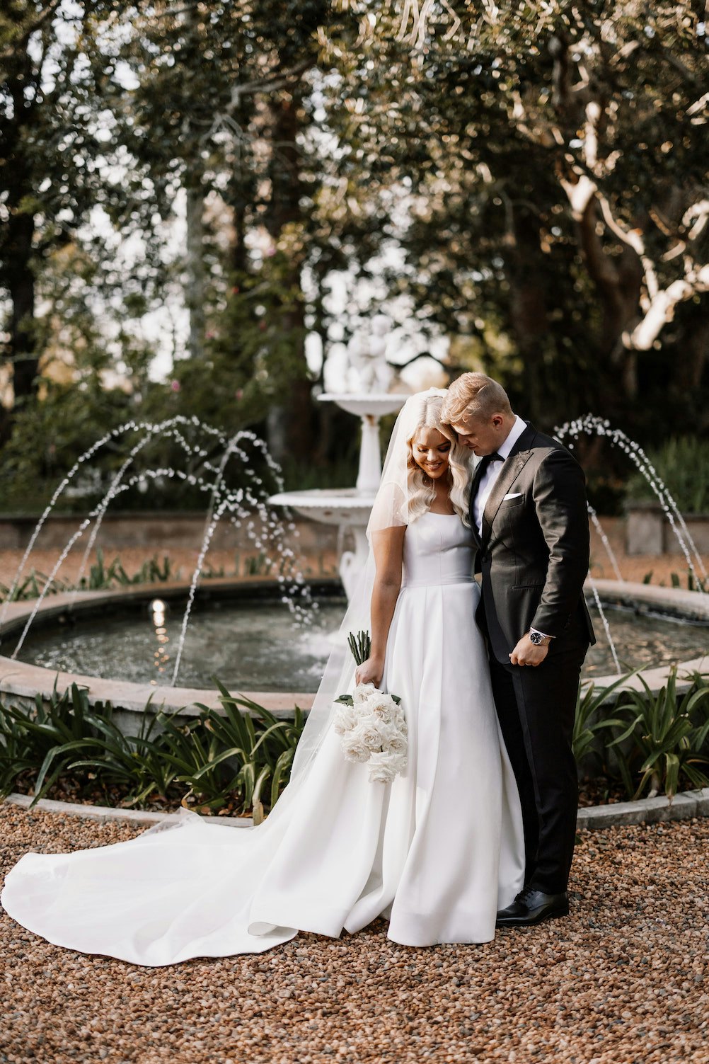 Bride and groom in front of fountain