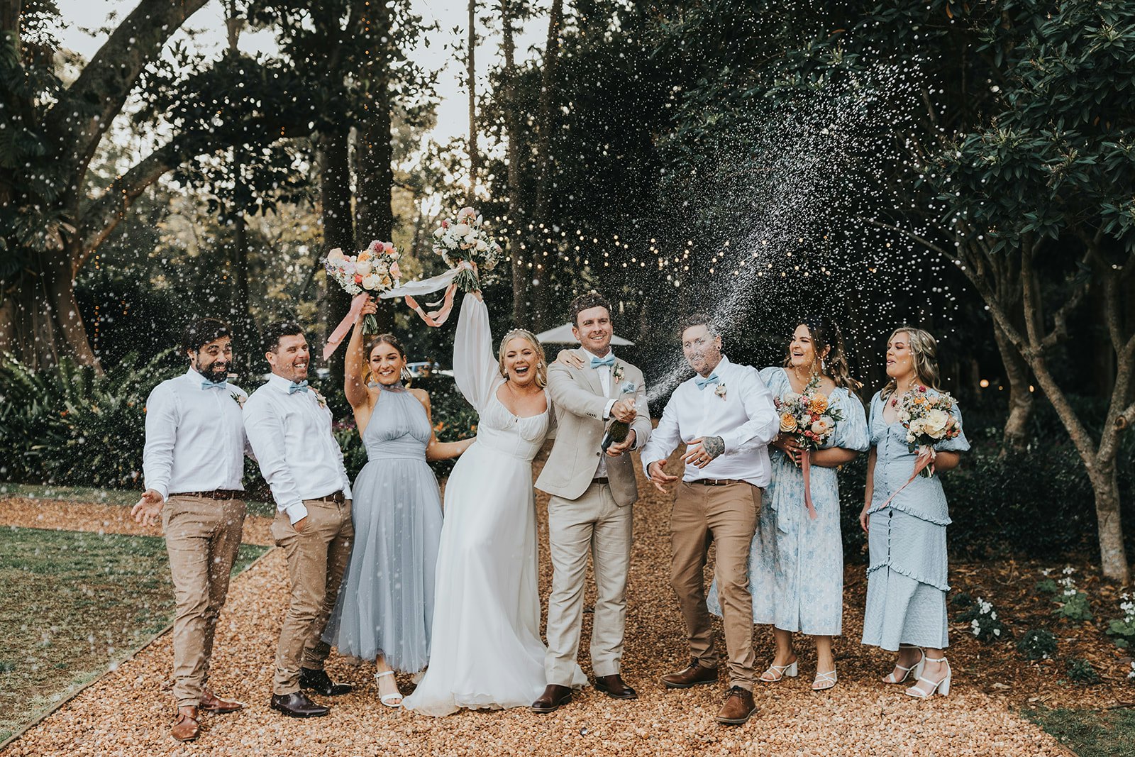 Wedding party spraying champagne