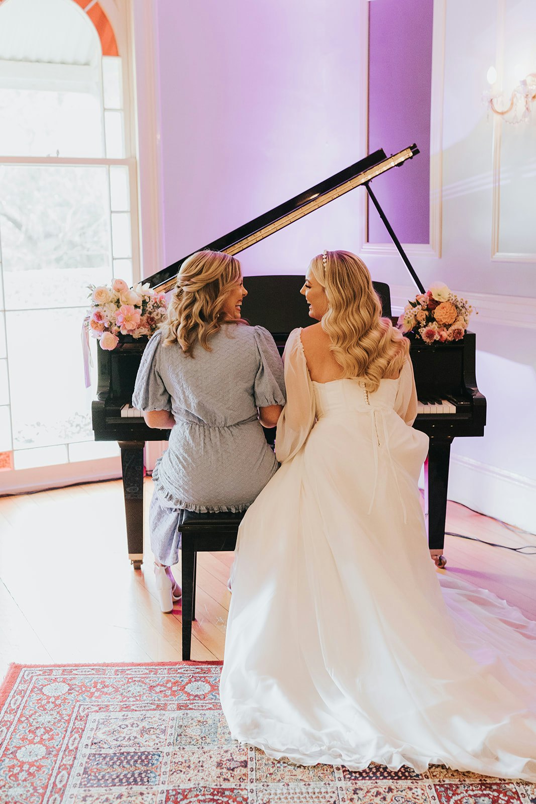 Bride and bridesmaid playing piano