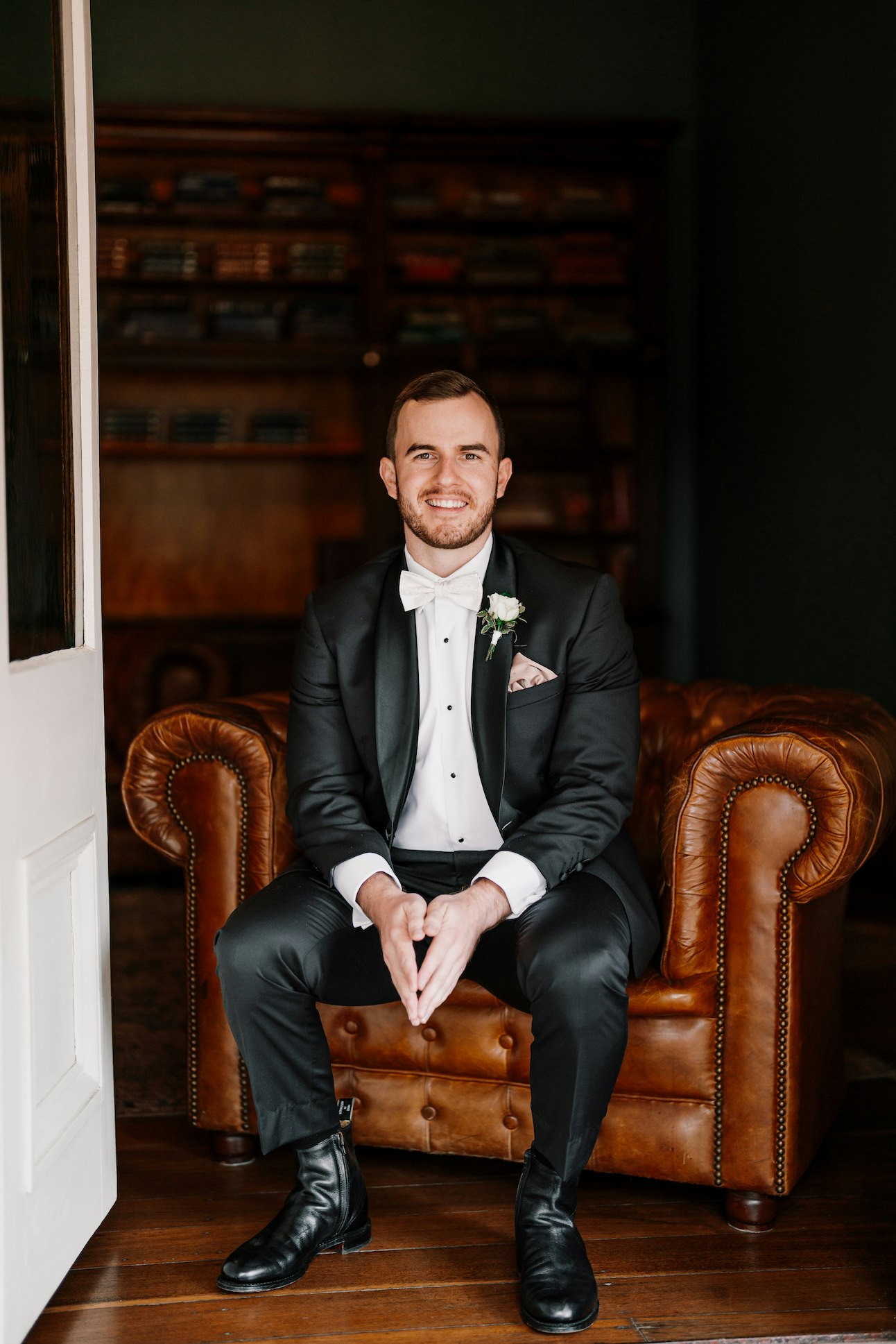 Groom sitting in leather chair