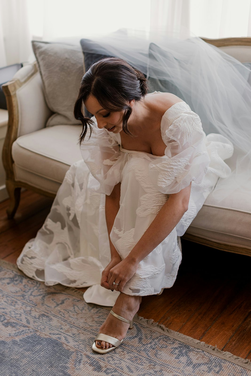 Bride doing up her shoes