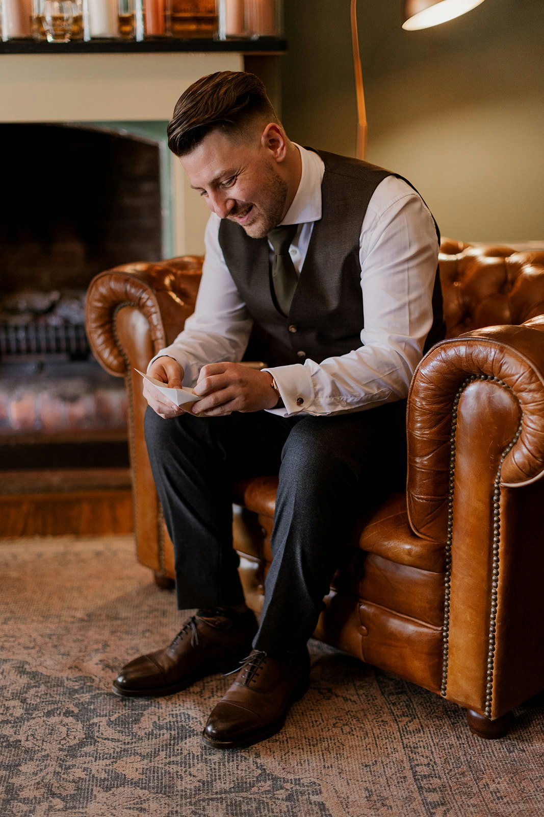Groom reading card from wife on wedding day