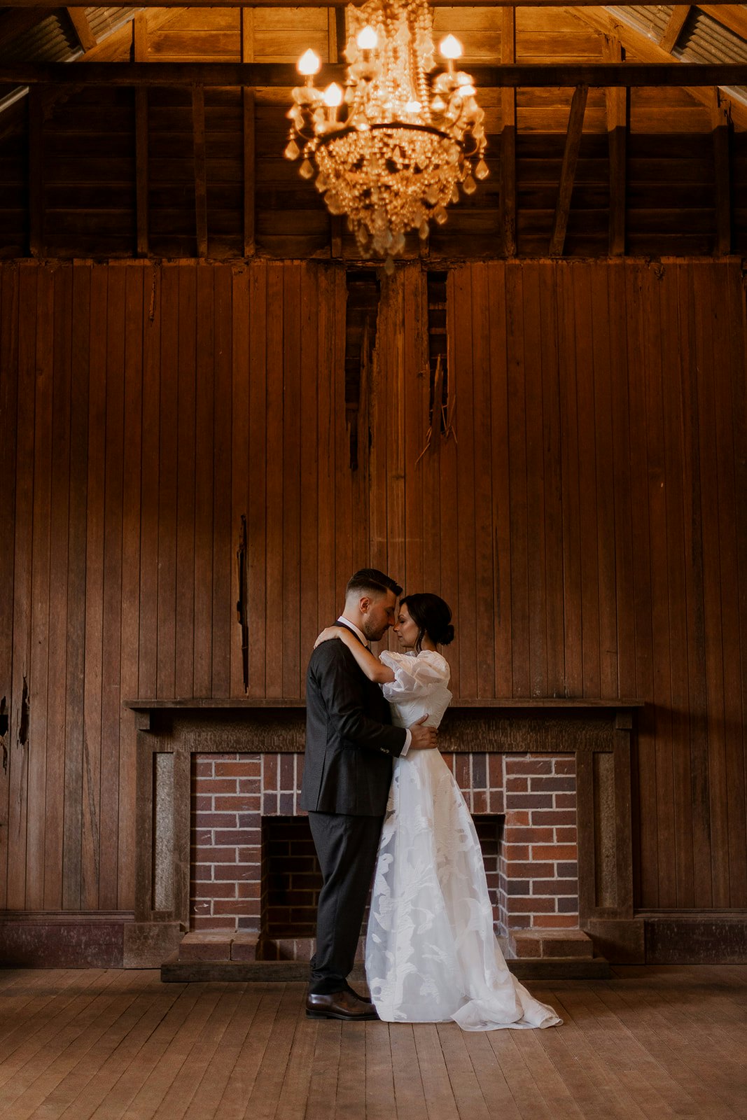 Bride and groom dancing under chandelier