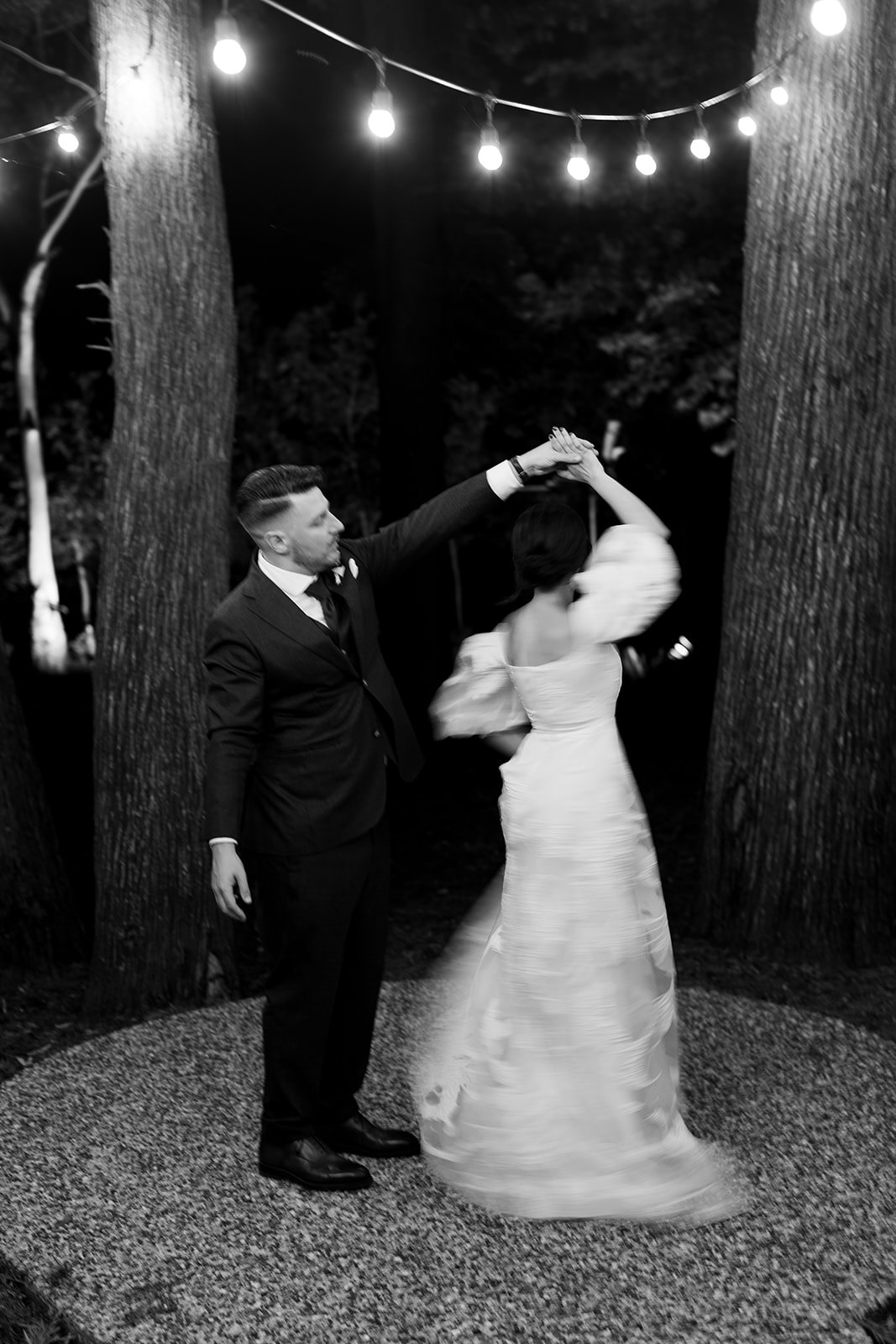 Bride and groom dancing in woods