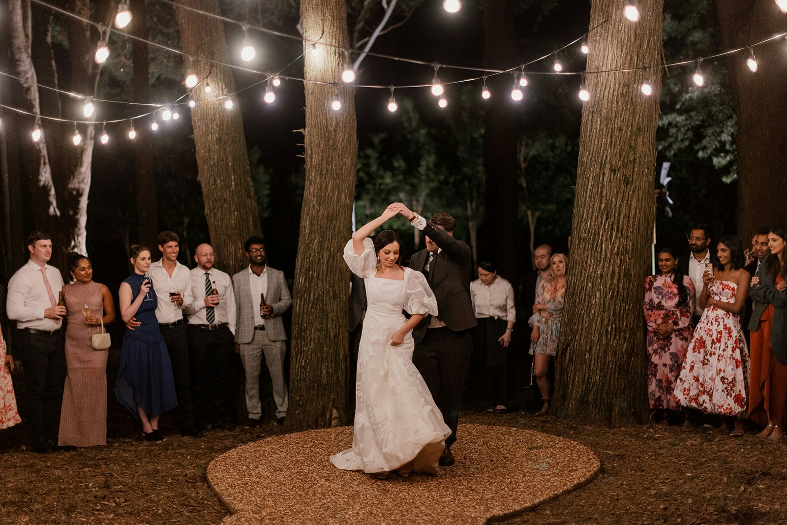 Bride and groom dancing in the woods