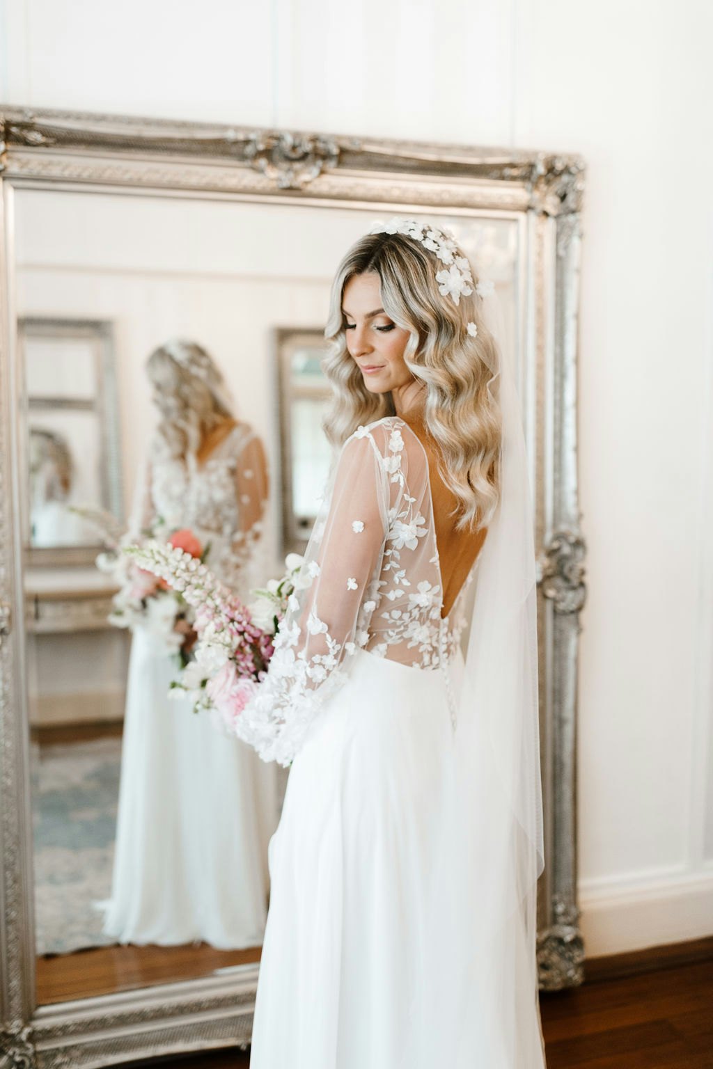 Bride standing in front of mirror
