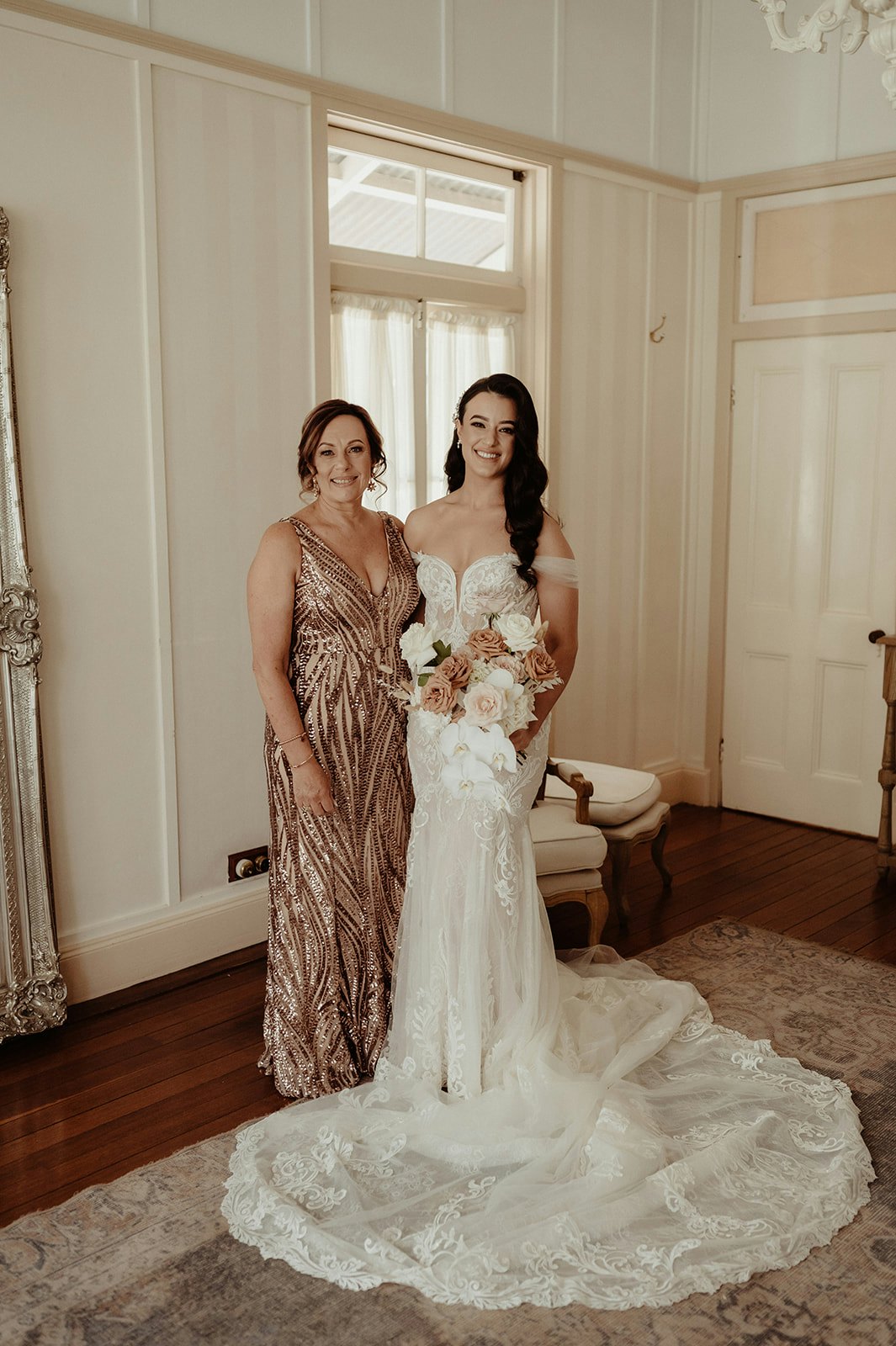 Bride and mother of the bride posing