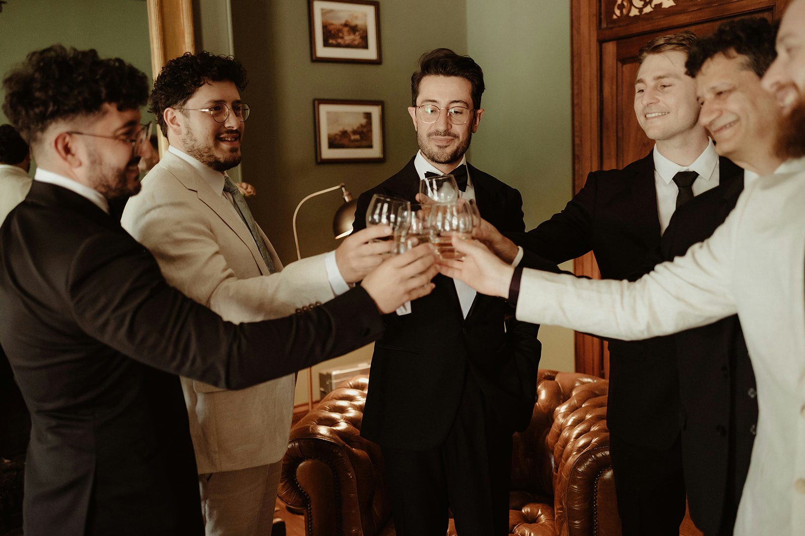 Groom and groomsmen drinking whisky