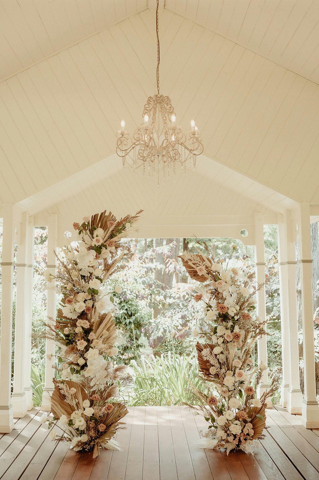 Wedding arbour with roses and dried palm fronds