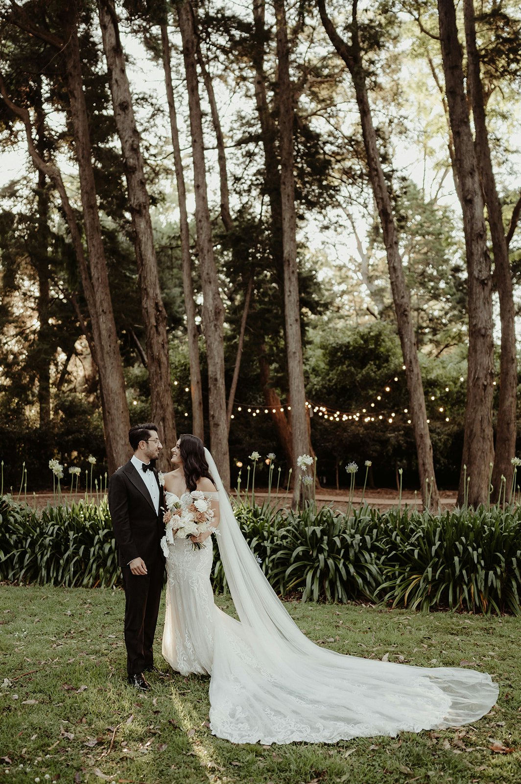 Bride and groom standing in gardens